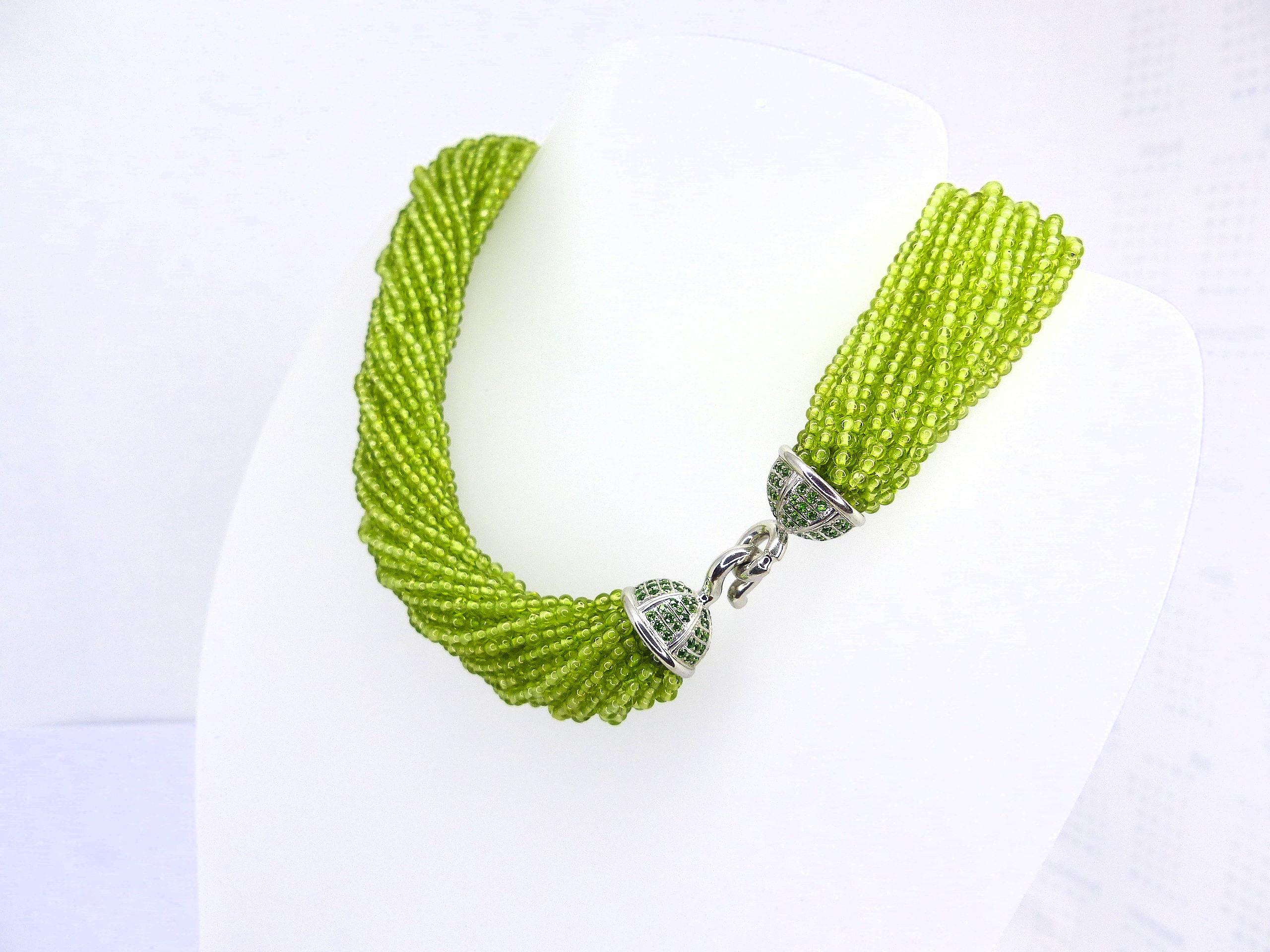 Thomas Leyser is renowned for his contemporary jewellery designs utilizing fine gemstones.

This necklace with 26x ropes with Peridot beads (2.5mm) with a 18k White Gold Clasp set with 144x fine Tsavorites (facetted, 1.5mm).

