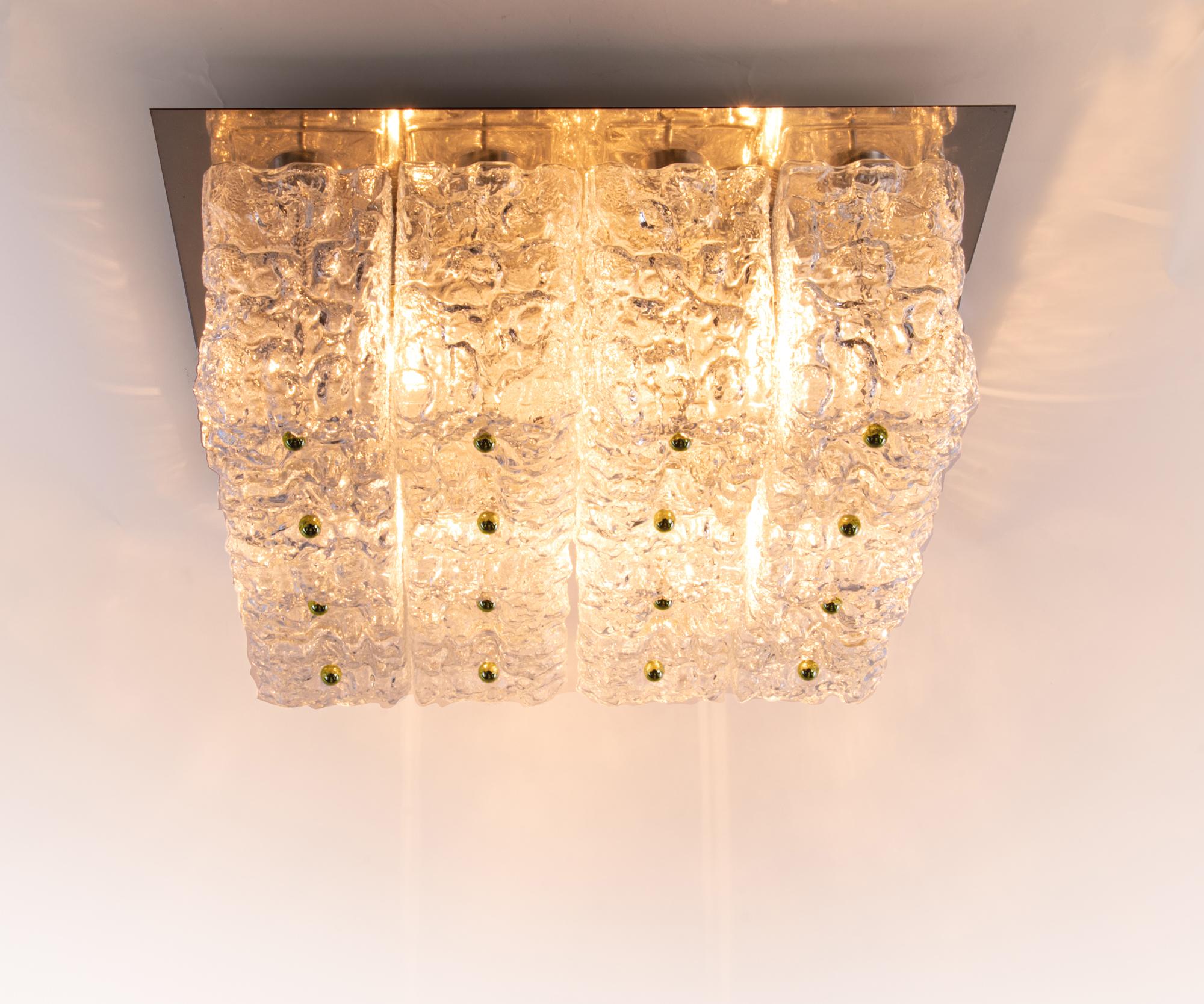 Elegant large cubist flush mount ceiling lamp with sixteen large glass blocks with a textured structure fixed on a golden brass frame with brass finals by the Finnish designer Helena Tynell attr. Gem from the time. Heavy design. Manufactured by