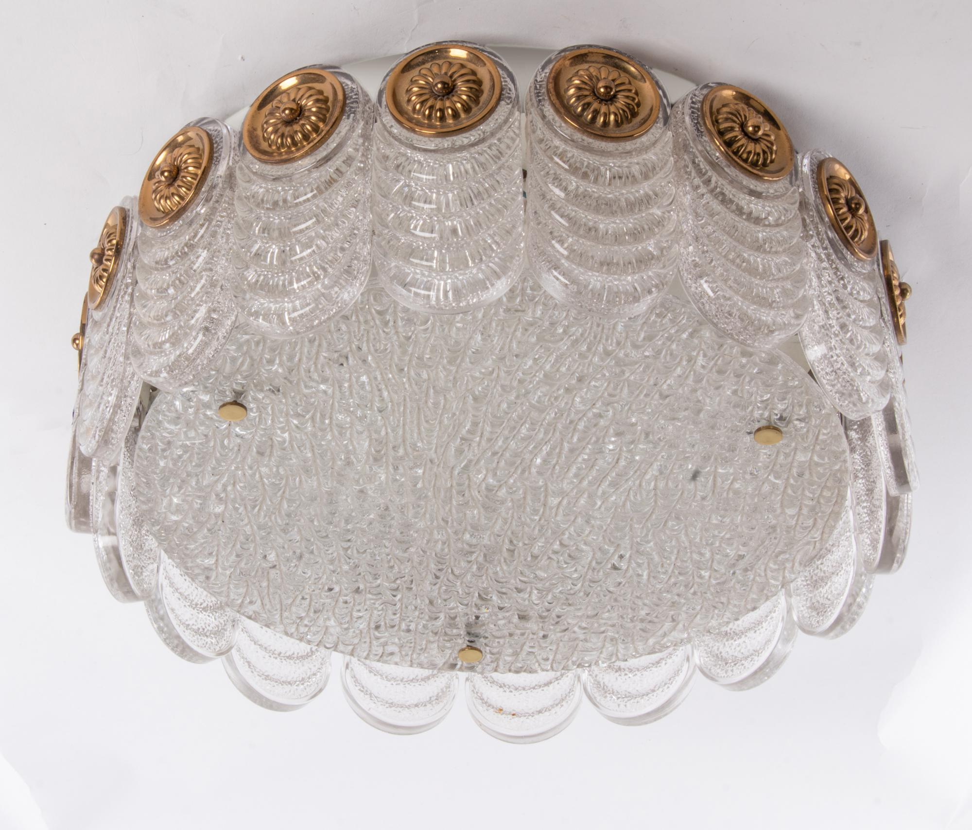 Elegant flush mount ceiling fixture made of heavy blown Murano glass on a white metal frame and with floral brass finals. Manufactured by Kaiser Lighting, Germany in the 1960s. 
 
Materials: Murano glass and brass. 
Colors: clear, golden and