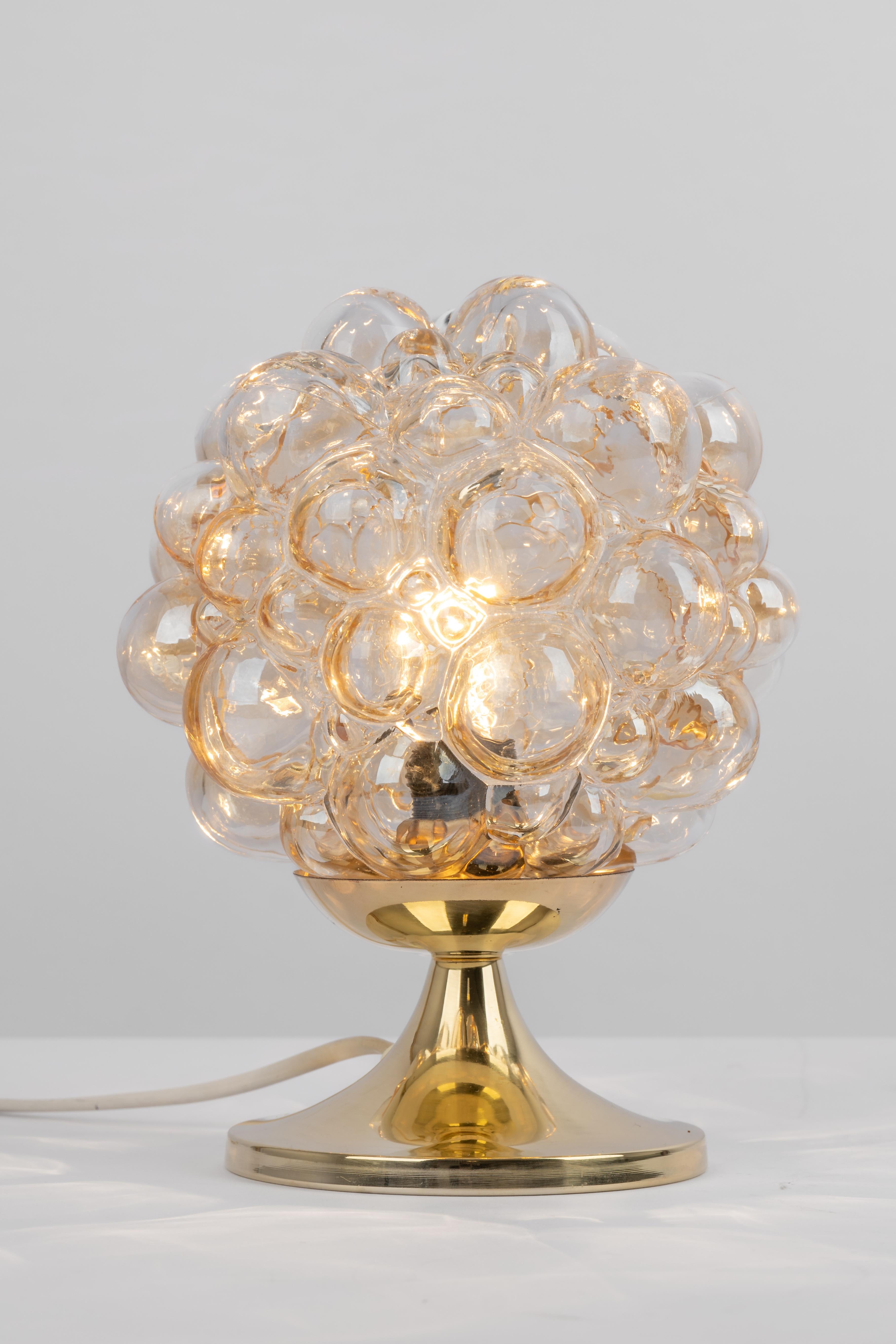 One of two amber bubble glass table lights made in Germany.
Very good condition. Cleaned, well-wired and ready to use. 
Wonderful light effect.

Each lamp requires 1 x E14 small bulbs with 40W max each.
Light bulbs are not included. It is possible
