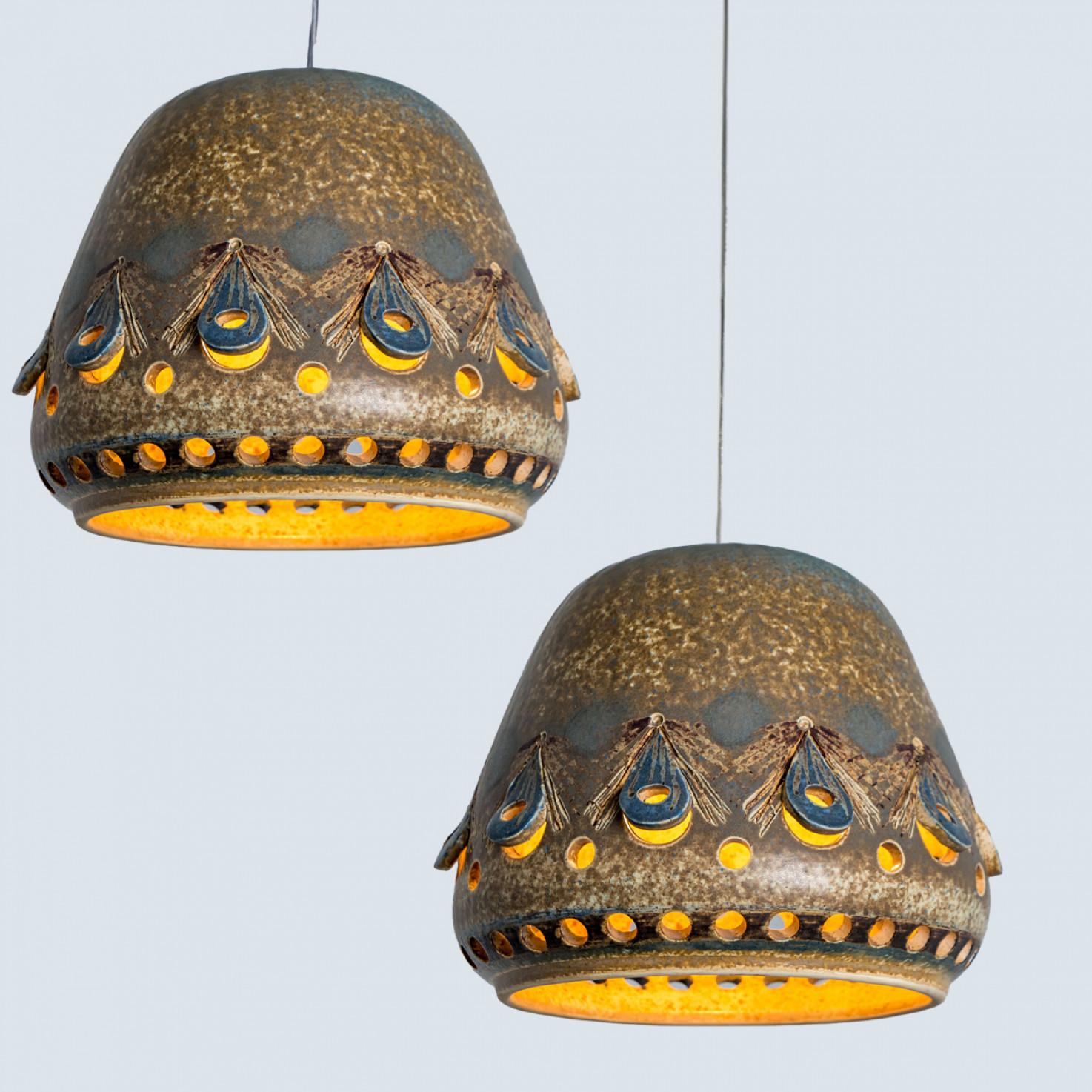 Stunning round pendant lamp with an unusual shape, made with rich colored brown and beige ceramics, manufactured in the 1970s in Denmark.

Dimensions:
Diameter: 11.81