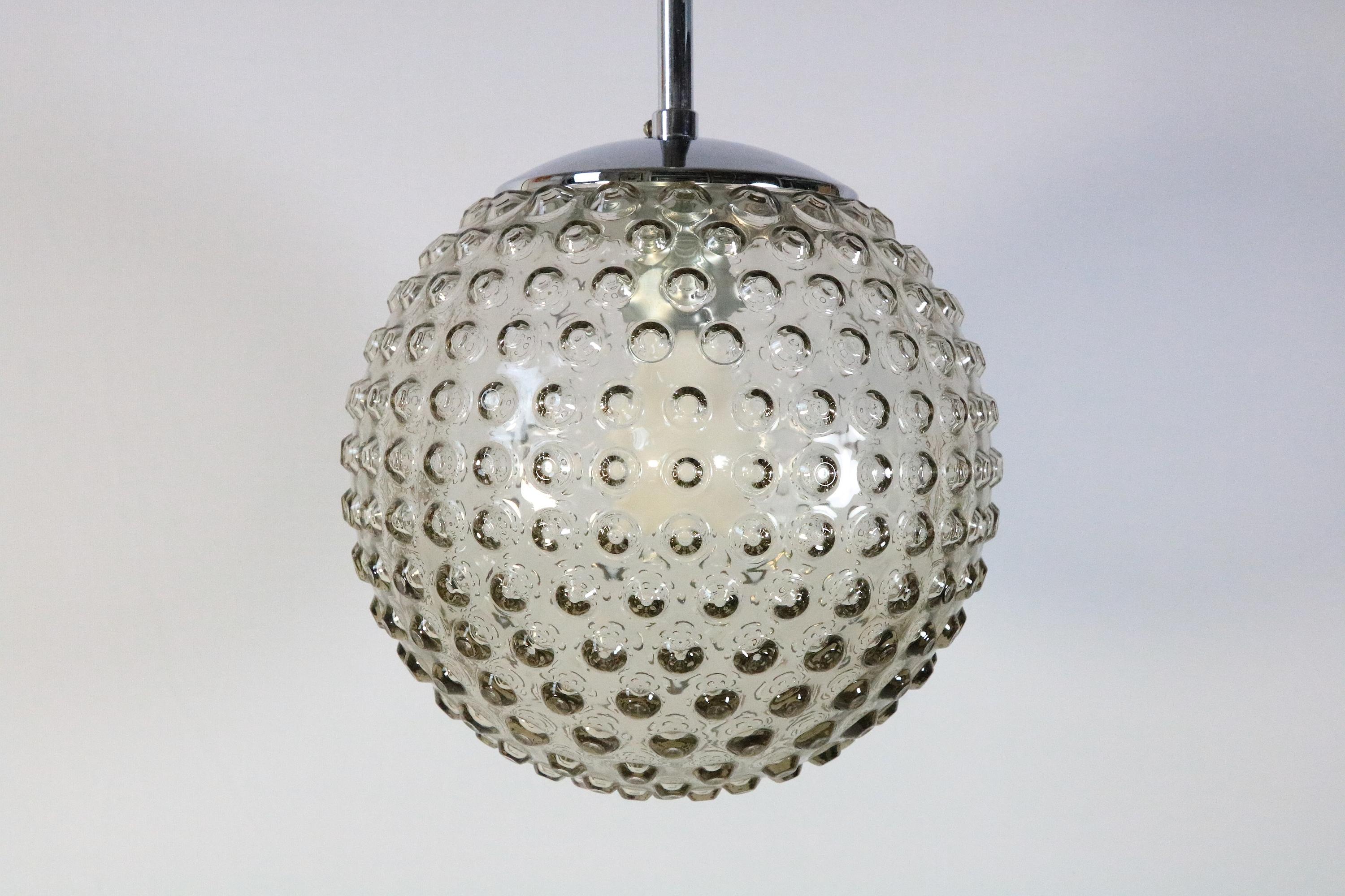 One of twocClassic ball lamps with bubble relief. Original from the 1970s.
 
Glass / chrome
 
Manufacturer: Staff, Germany
Design: Rolf Krüger

Diameter: 24 cm / 9.45 inches
Cable length on request.

It is a perfect addition to any mid-century style