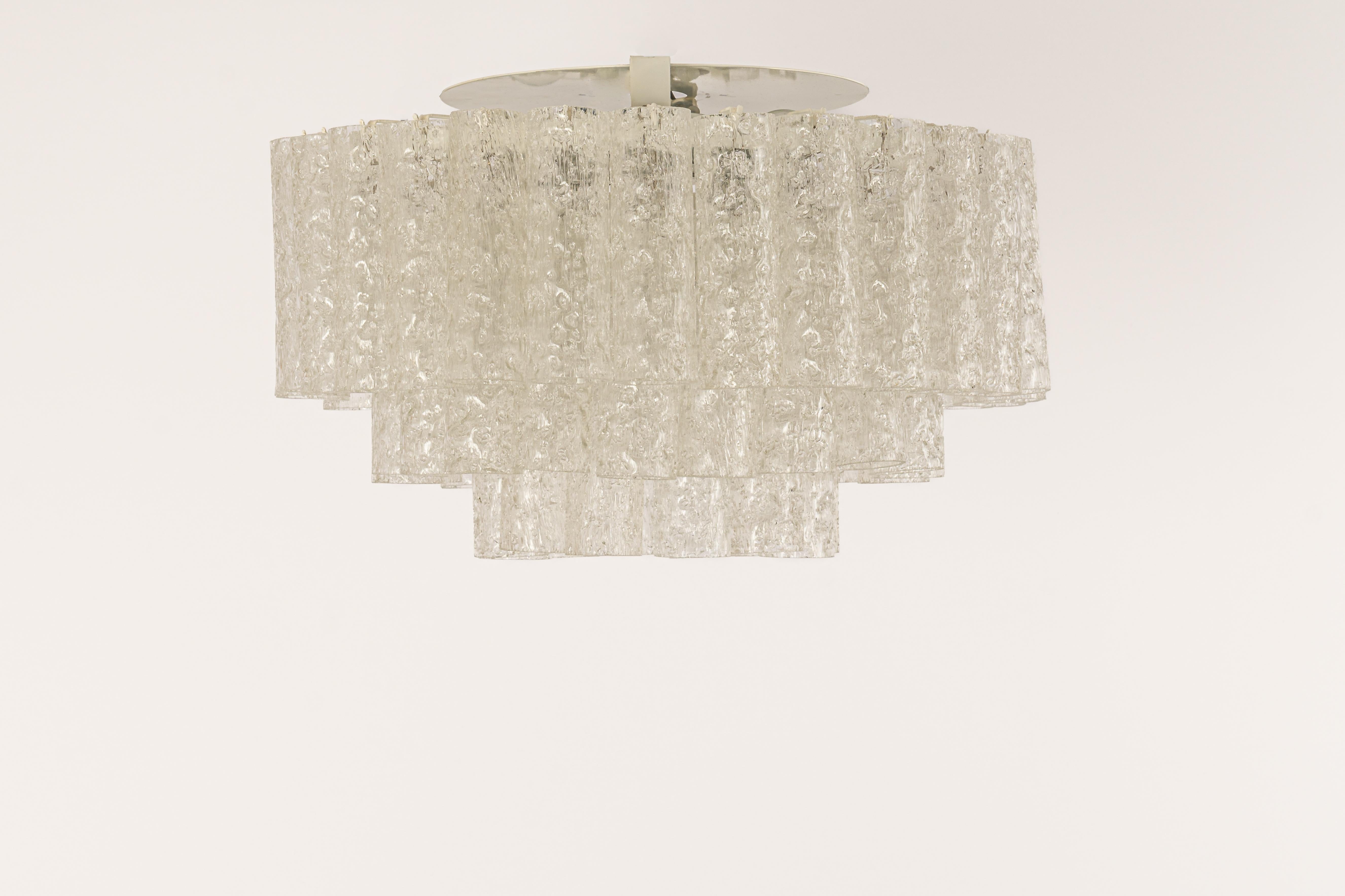 Fantastic three-tier midcentury chandelier by Doria, Germany, manufactured circa 1960-1969. 3 rings of Murano glass cylinders suspended from a fixture.

Sockets: 4 x E14 candelabra bulbs (up to 40 W each) + 1 x E27 Standard
Light bulbs are not