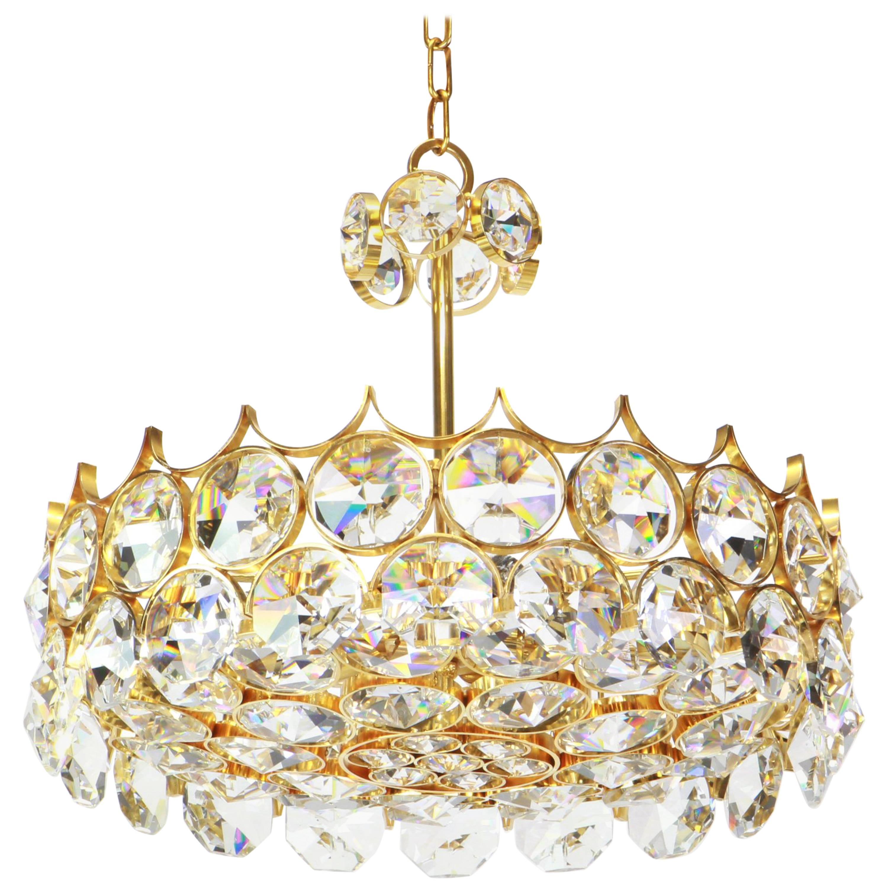 A wonderful and high quality gilded chandelier/pendant light fixture by Palwa (Palme & Walter), Germany, 1970s

It is made of a 24-carat gold-plated brass frame decorated with hundreds of cut crystal glass. The bottom is made of a round cut glass
