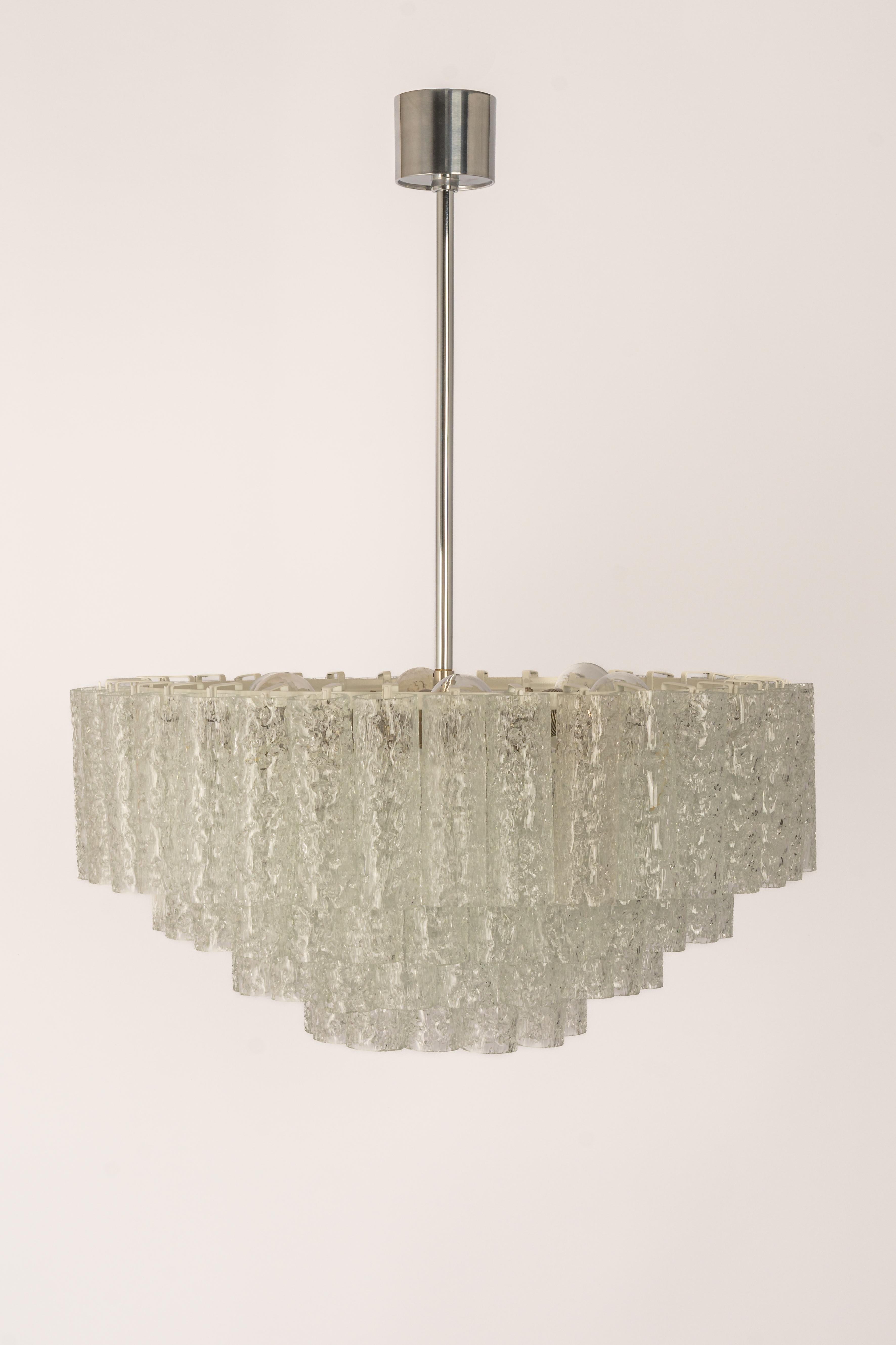 Fantastic four-tier midcentury chandelier by Doria, Germany, manufactured circa 1960-1969. 4 rings of Murano glass cylinders suspended from a fixture.

Sockets: 10 x E14 candelabra bulbs (up to 40 W each) .
Light bulbs are not included. It is