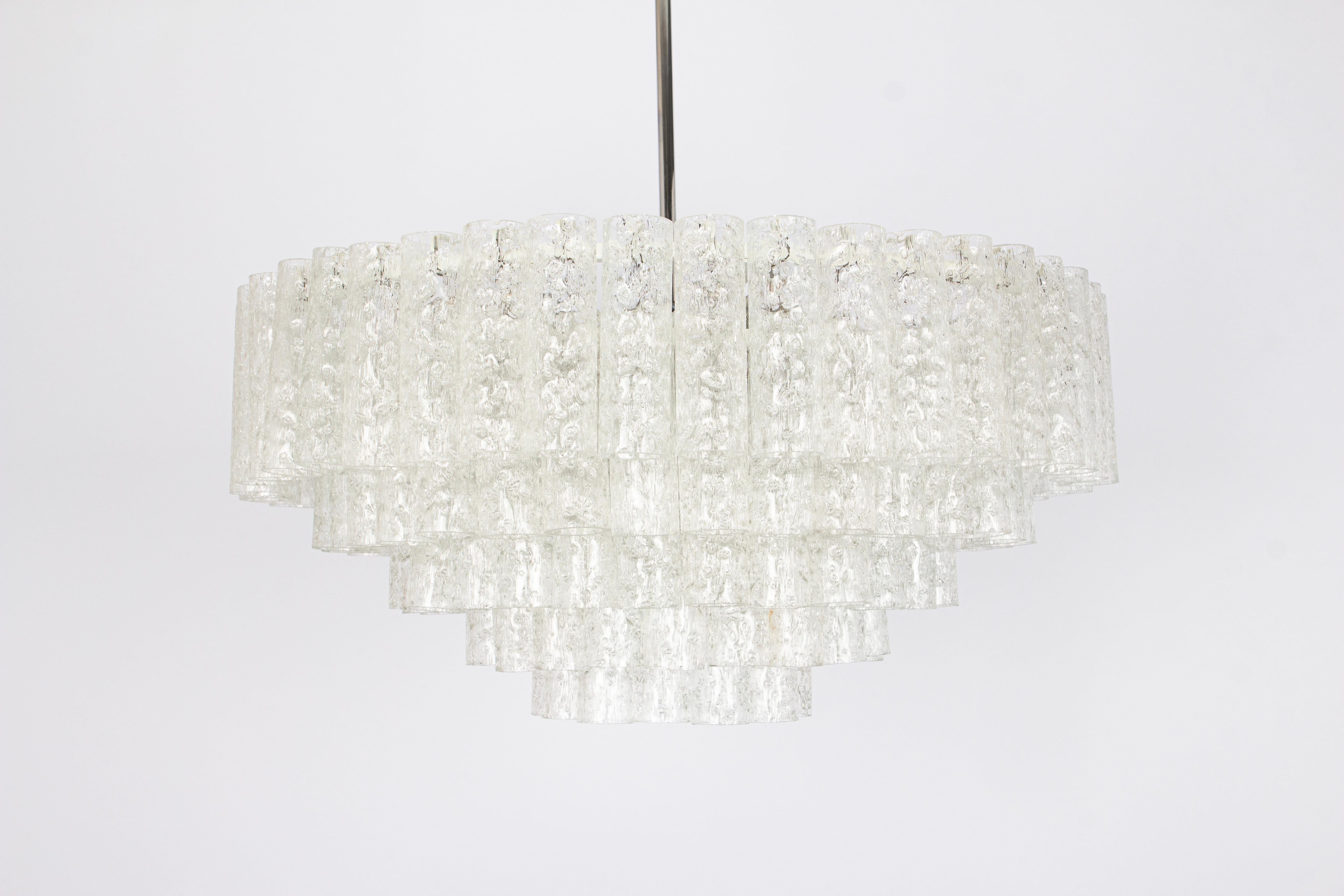 Fantastic five-tier midcentury chandelier by Doria, Germany, manufactured circa 1960-1969. 5 rings of Murano glass cylinders suspended from a fixture.

Sockets: 16 x E14 candelabra bulbs (up to 40 W each) .
Light bulbs are not included. It is