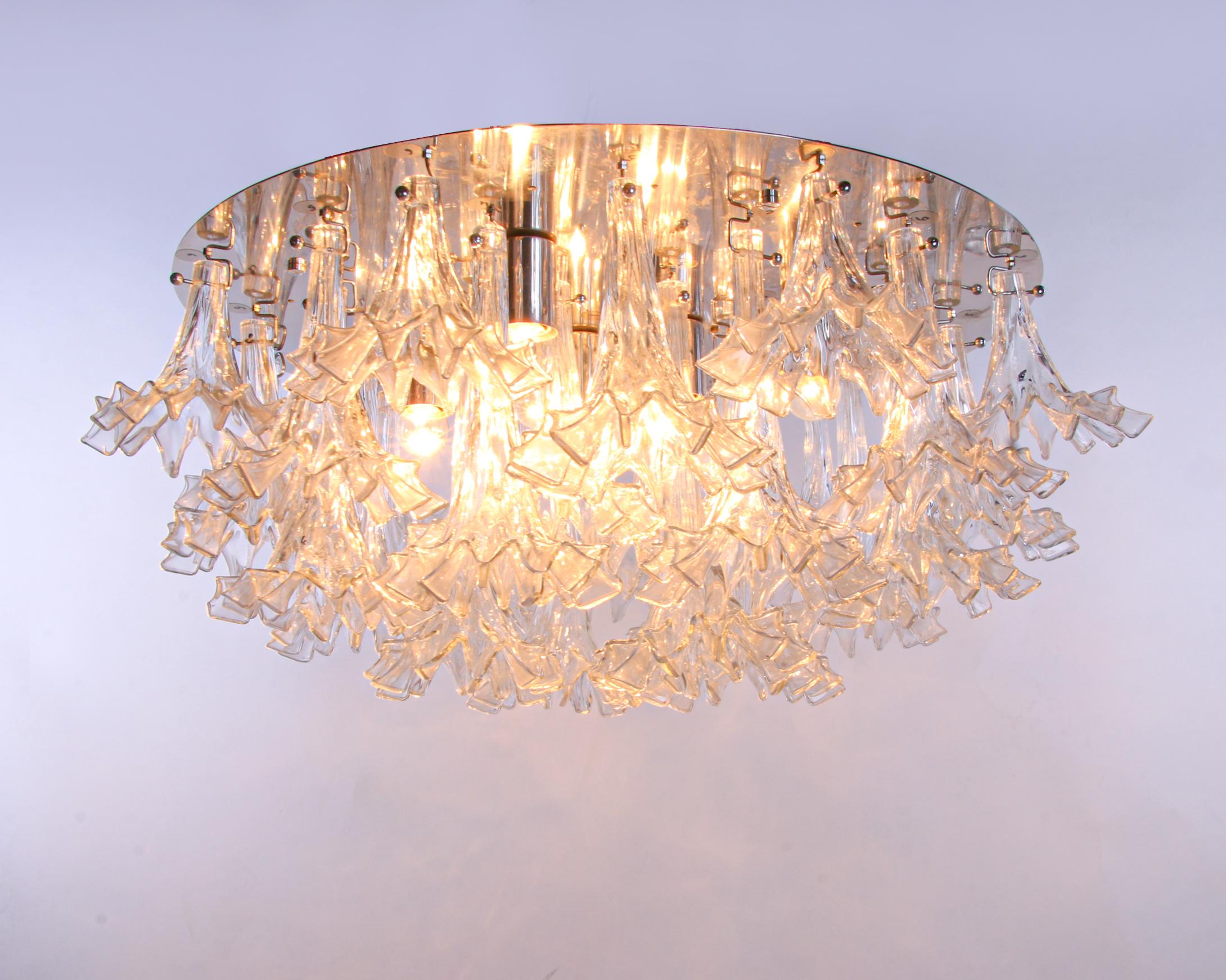 Spectacular large flush mount chandelier model 'Arethusa' with individually handcrafted Murano glass flowers on a chromed metal structure. Chandelier illuminates beautifully and offers a lot of light. Gem from the time. With this light you make a