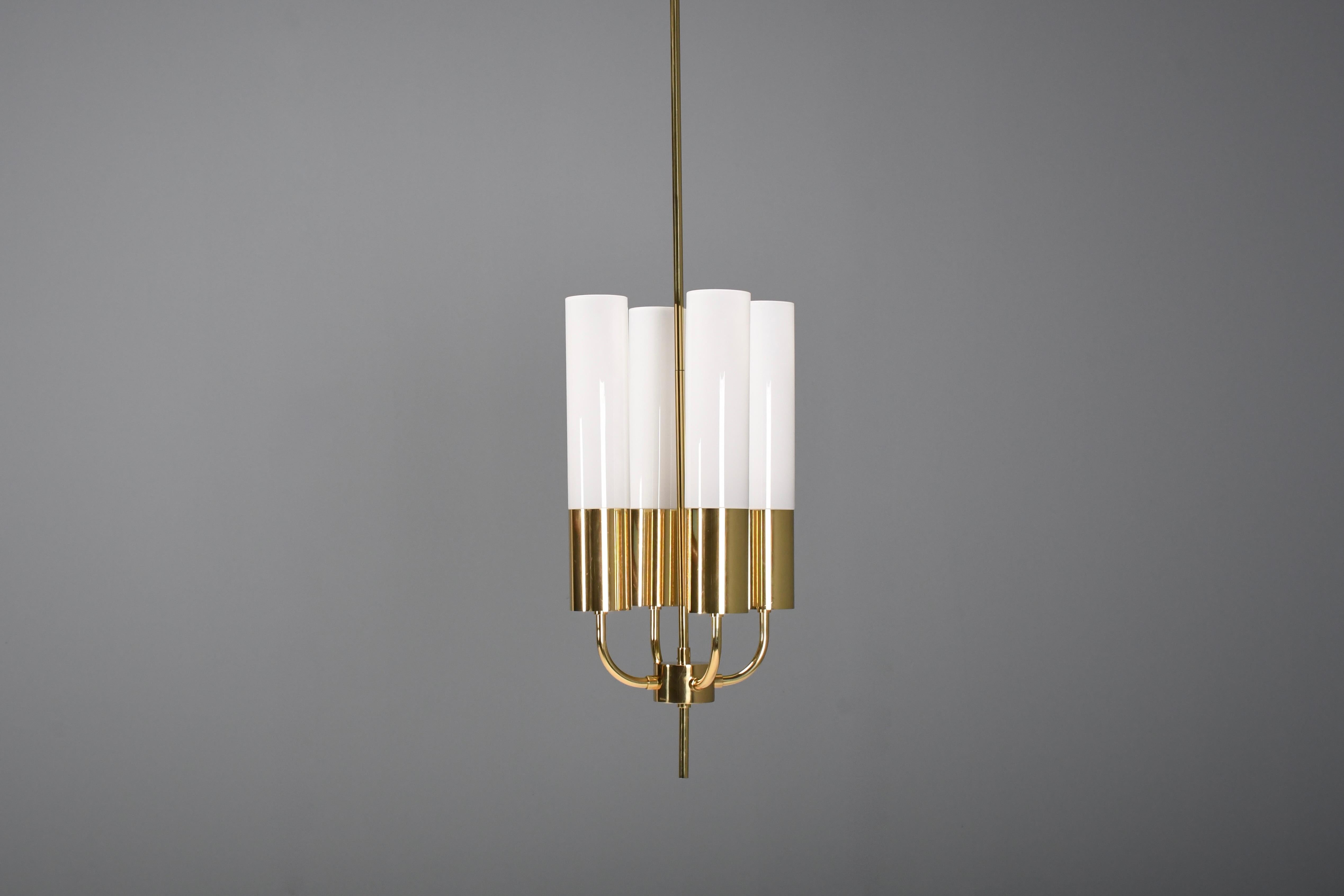 Beautiful large 1970s Chandelier in very good condition.

We have two of these chandeliers available.

The chandelier is produced by Glashütte Limburg in the 1970s.

It is made from solid polished brass and has four arms with four opaline glass