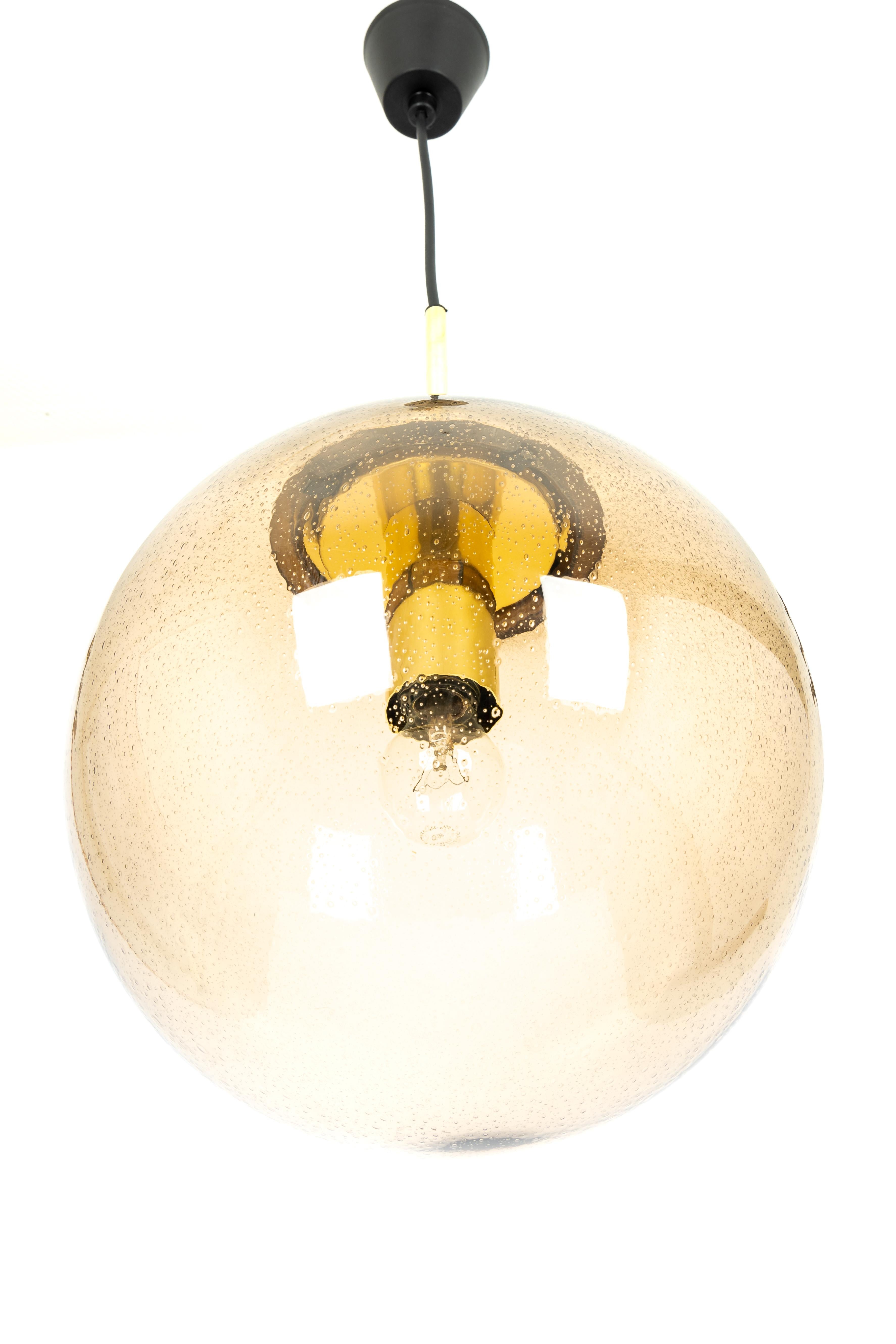 1 of 2 Large smoked glass ball pendants, manufactured by Limburg, Germany, circa 1970-1979.

Sockets: One x E27 standard bulb 
Light bulbs are not included. It is possible to install this fixture in all countries (US, UK, Europe, Asia,