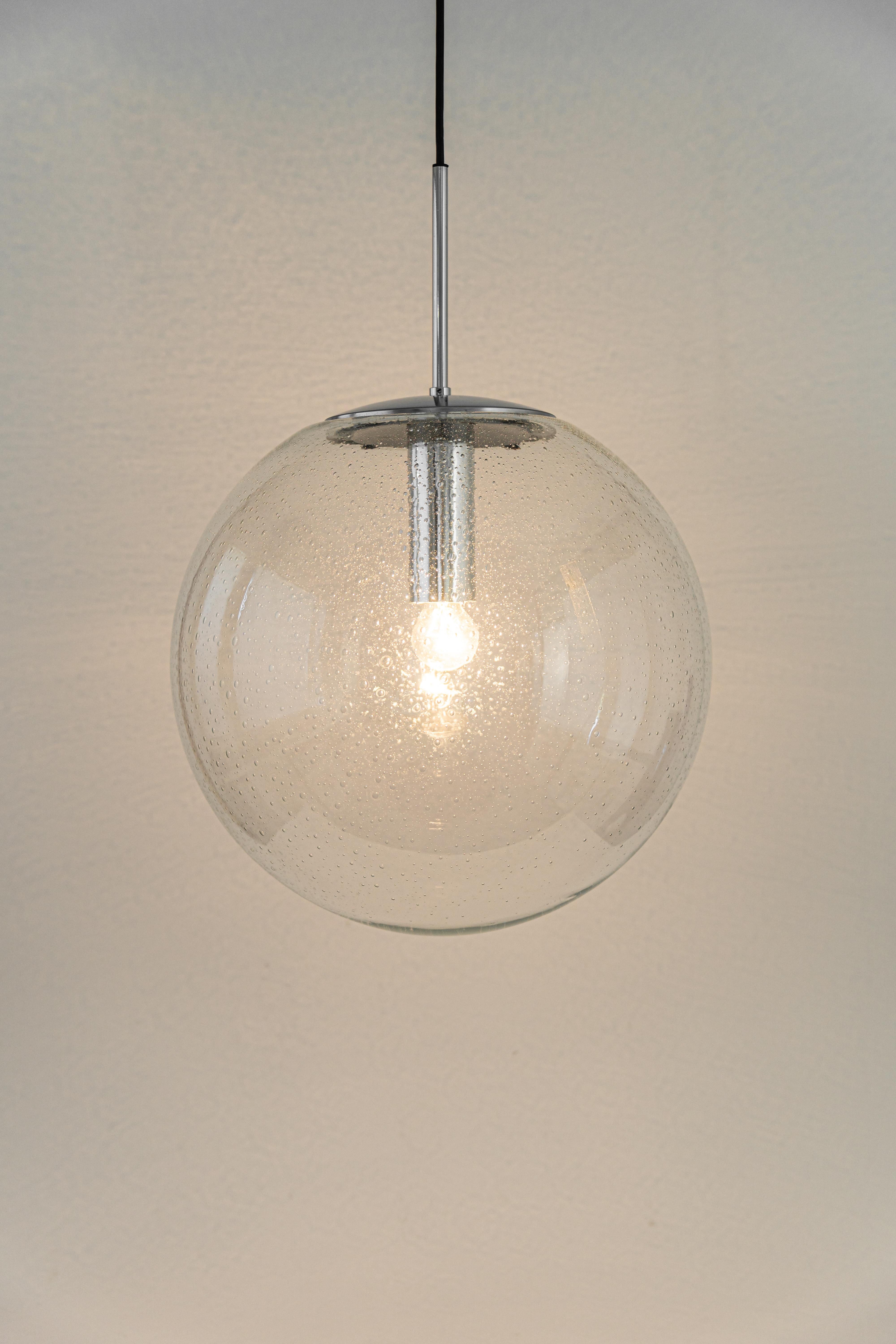 1 of 2 large glass ball pendants, manufactured by Limburg, Germany, circa 1970-1979.

Sockets: One x E27 standard bulb 
Light bulbs are not included. It is possible to install this fixture in all countries (US, UK, Europe, Asia,