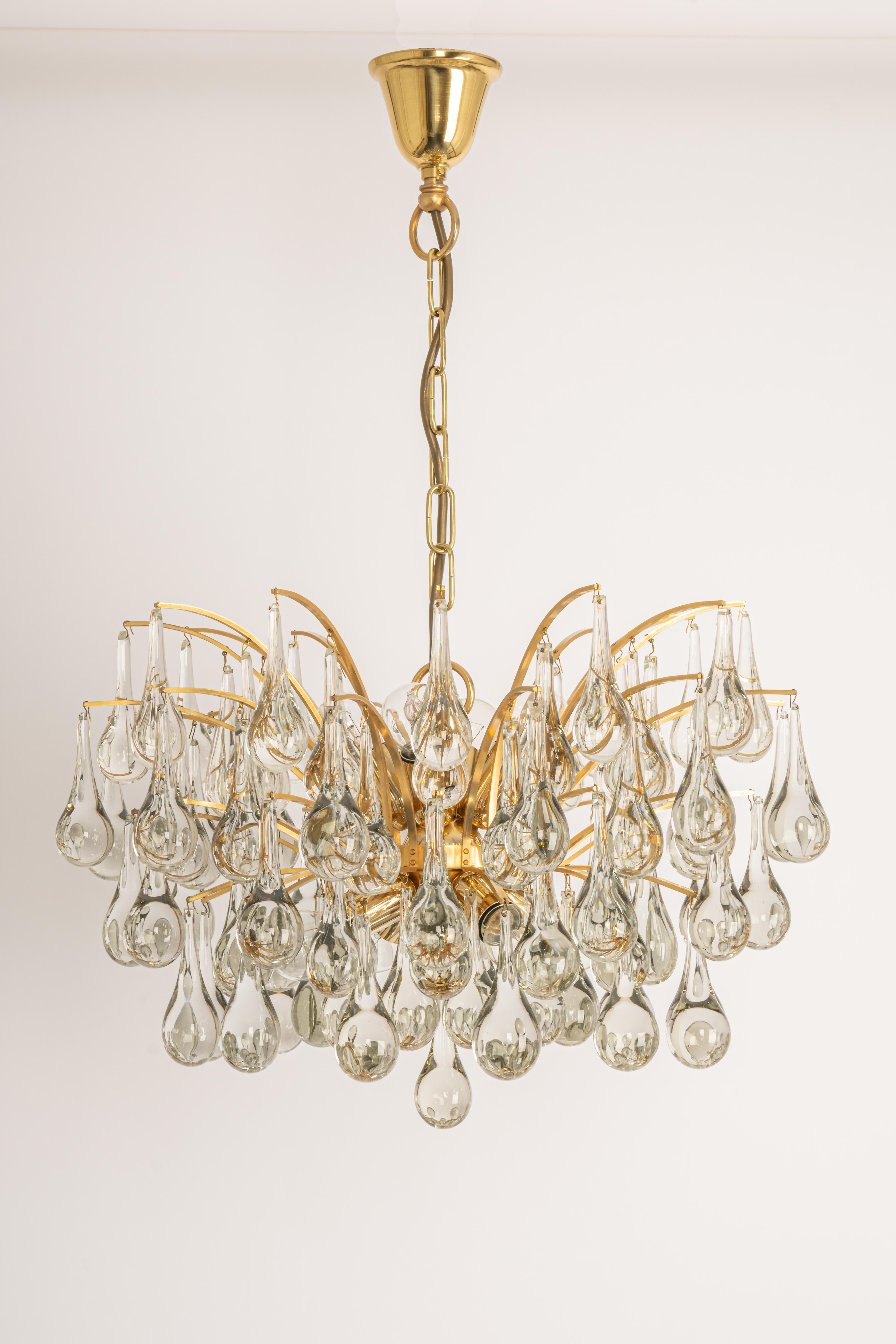 1 of 2 stunning chandeliers by Christoph Palme, Germany, manufactured in the 1970s. It’s composed of Murano teardrop glass pieces on a gilded brass frame.

High quality and in very good condition. Cleaned, well-wired, and ready to use. 

The