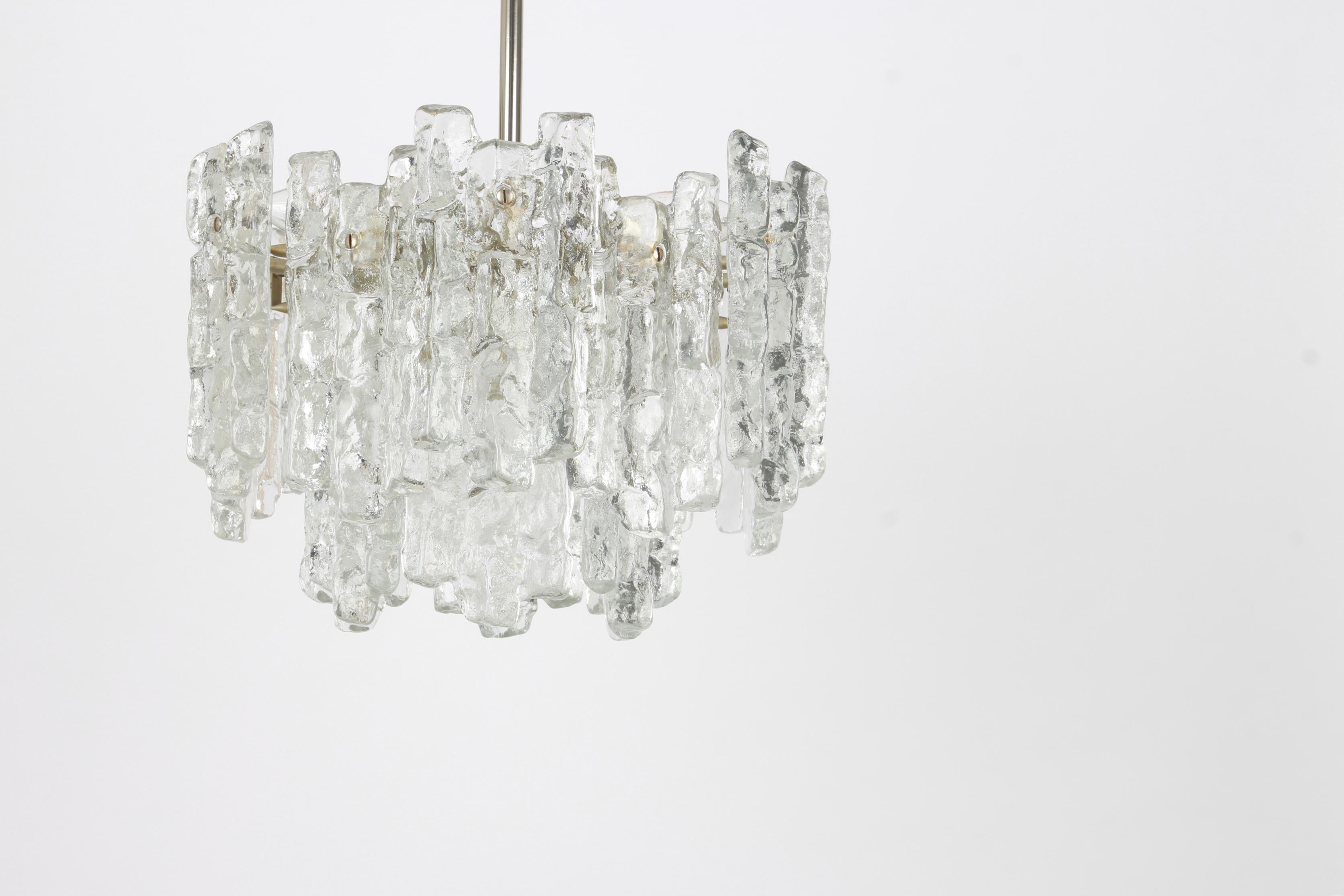 Stunning Murano glass chandelier by Kalmar, 1960s
Two tiers structure gathering 18 structured glasses, beautifully refracting the light very heavy quality.
High quality and in very good condition. Cleaned, well-wired and ready to use.
The fixture