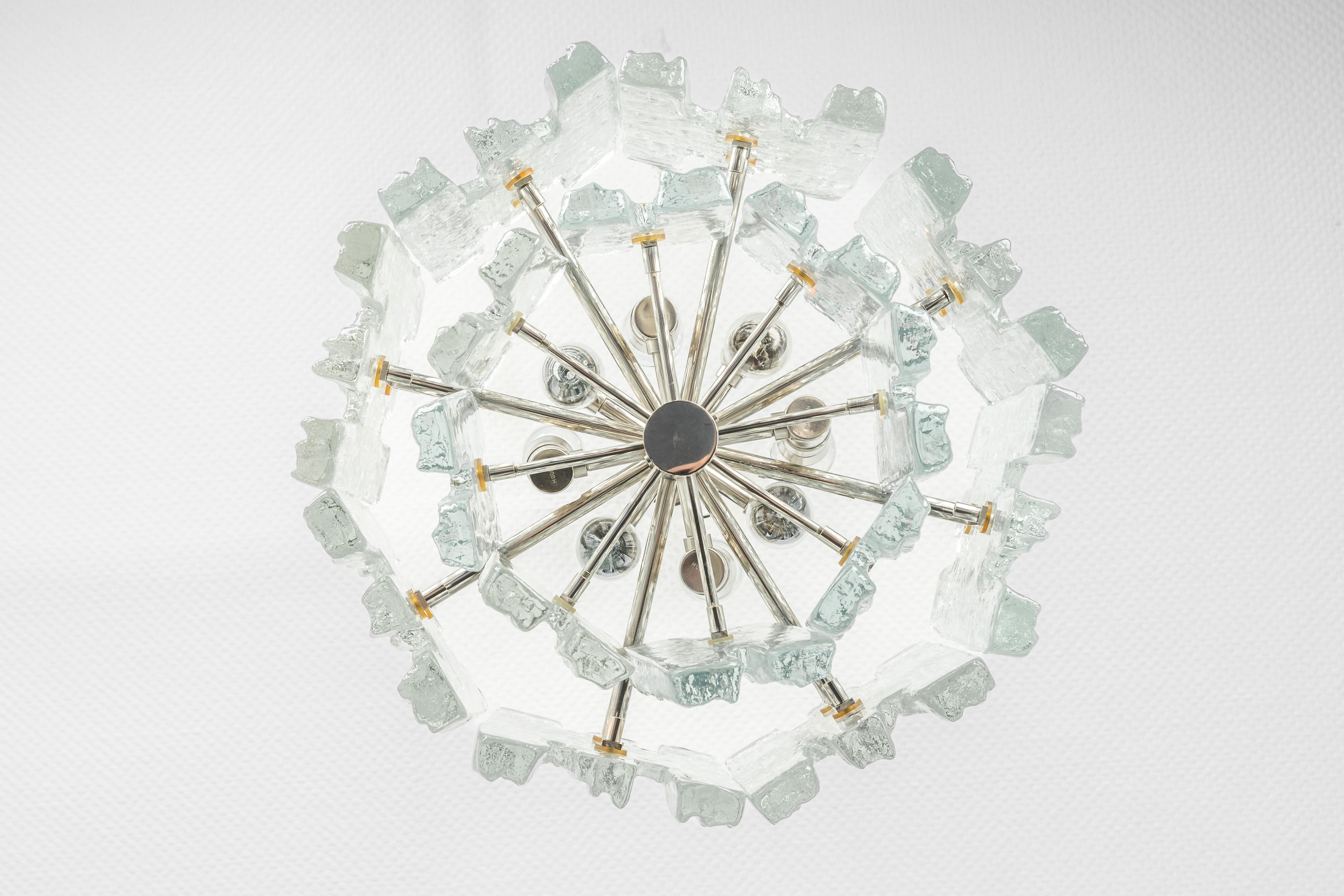 1 of 2 Stunning Murano glass chandelier by Kalmar, 1960s
Two tiers gather structured glasses, beautifully refracting the light very heavy quality.

High quality and in very good condition. Cleaned, well-wired, and ready to use. 

The fixture