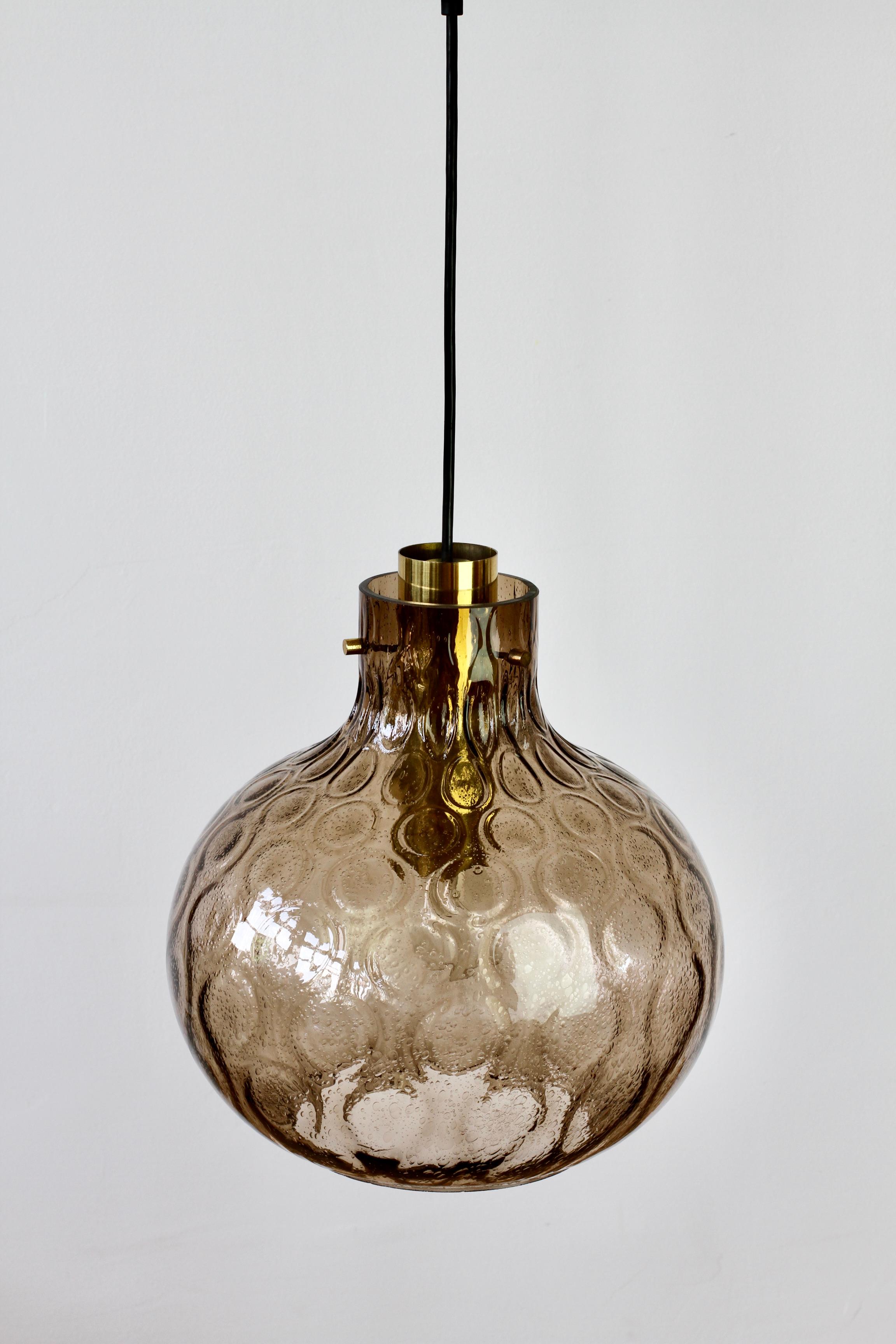 One of a pair of large vintage mid-century hanging bubble glass pendant lights / lanterns by Glashütte Limburg. Made in the late 1960s throughout to the late 1970s, these gorgeous lamps feature a mouth blown, bell shaped, smoked glass globe