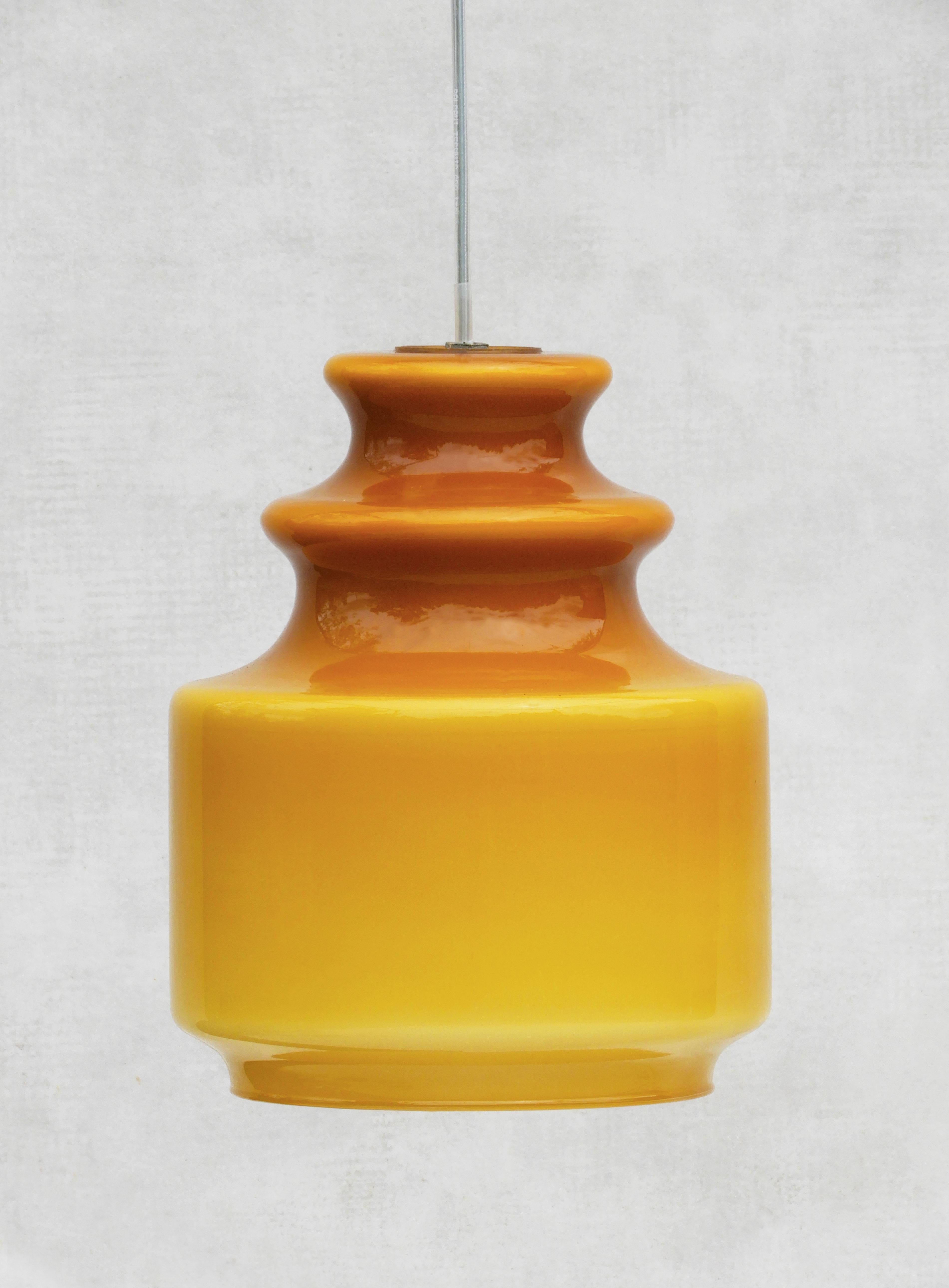 French Amber opaline ceiling lights from 70s France

A rare pair of original pendant Lights in high gloss caramel colour opaline glass with characteristic white interior layer giving off a wonderful diffused light when lit.  Original 'floating'