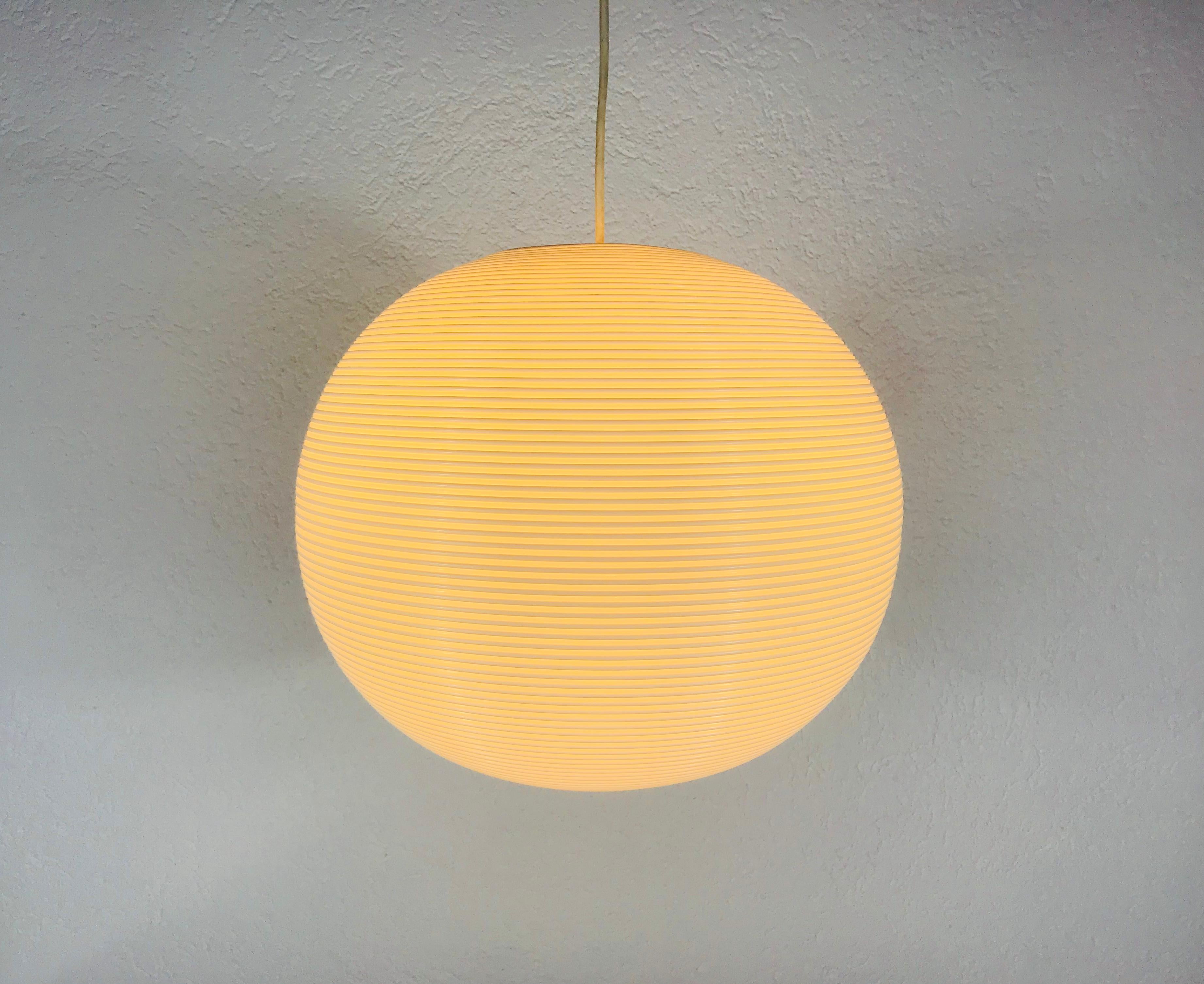 One of two Mid-Century Modern ball pendant lamp by Heifetz Rotaflex made in the 1960s. The lamp shade is made of continuous plastic cords spun into a ceiling fixture. The top of the lamp is hard plastic. Both lamps are in good vintage