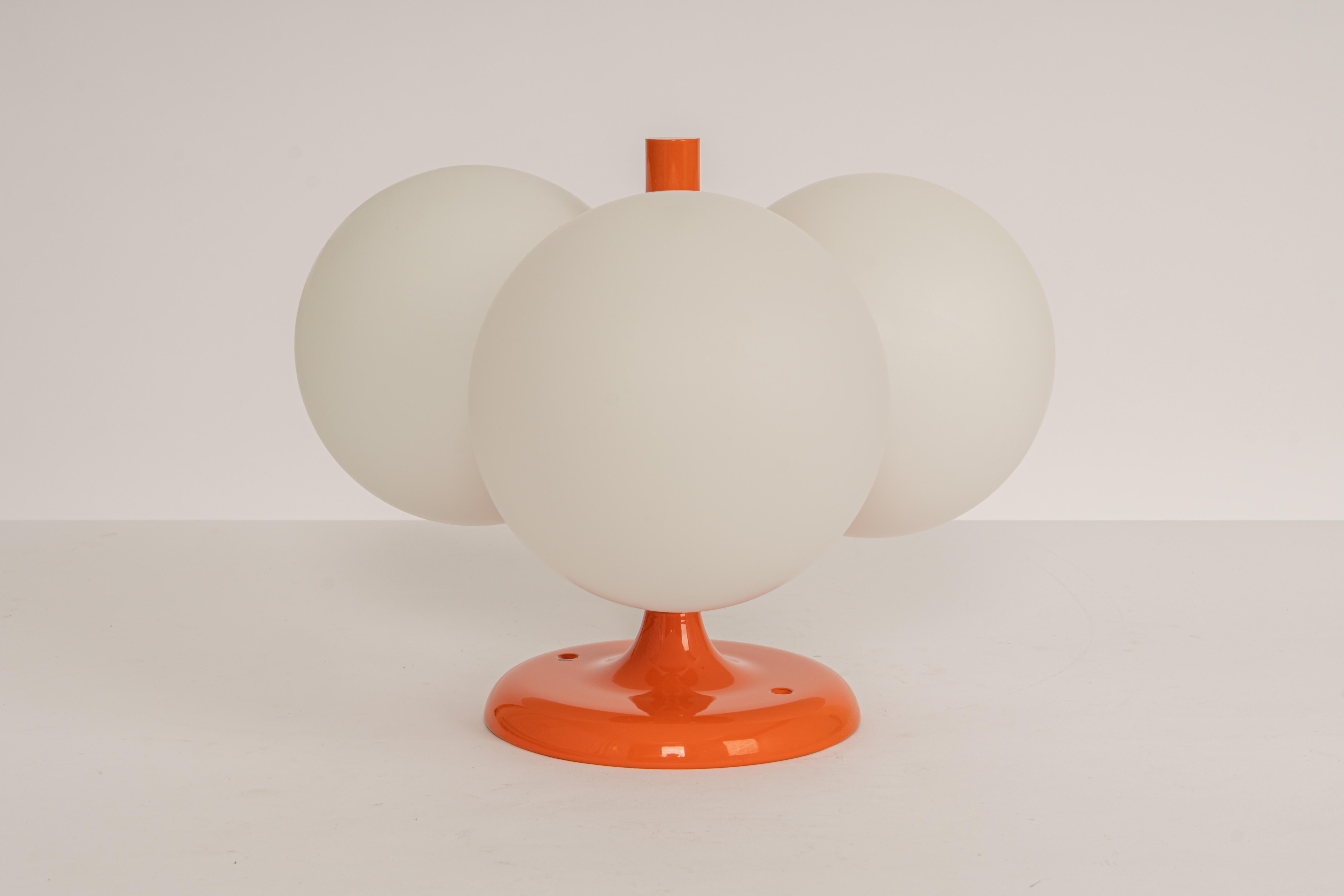 1 of 2 midcentury vintage ceiling or wall light in orange color made by Kaiser Leuchten, Germany with 3 opal glass balls.
High quality and in very good condition. Cleaned, well-wired, and ready to use. 

The fixture requires 3 x E14 small bulbs