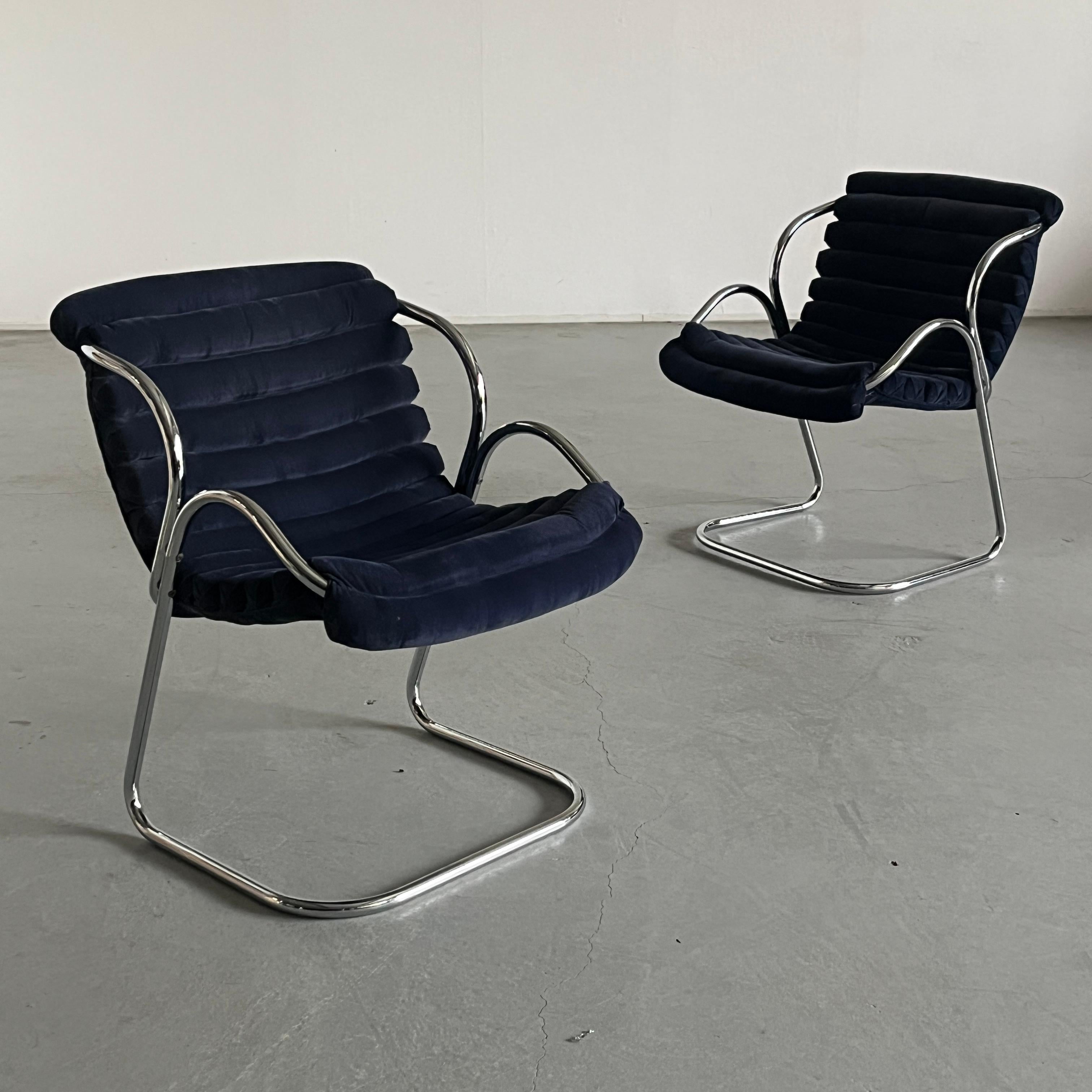 Rare and unique cantilever armchairs featuring beautifully upholstered blue velvet seating and a chromed steel base which branches out into the chairs’ armrests.
Produced in Italy in the 1970s.

Price is for a single piece.
One piece left.

Overall