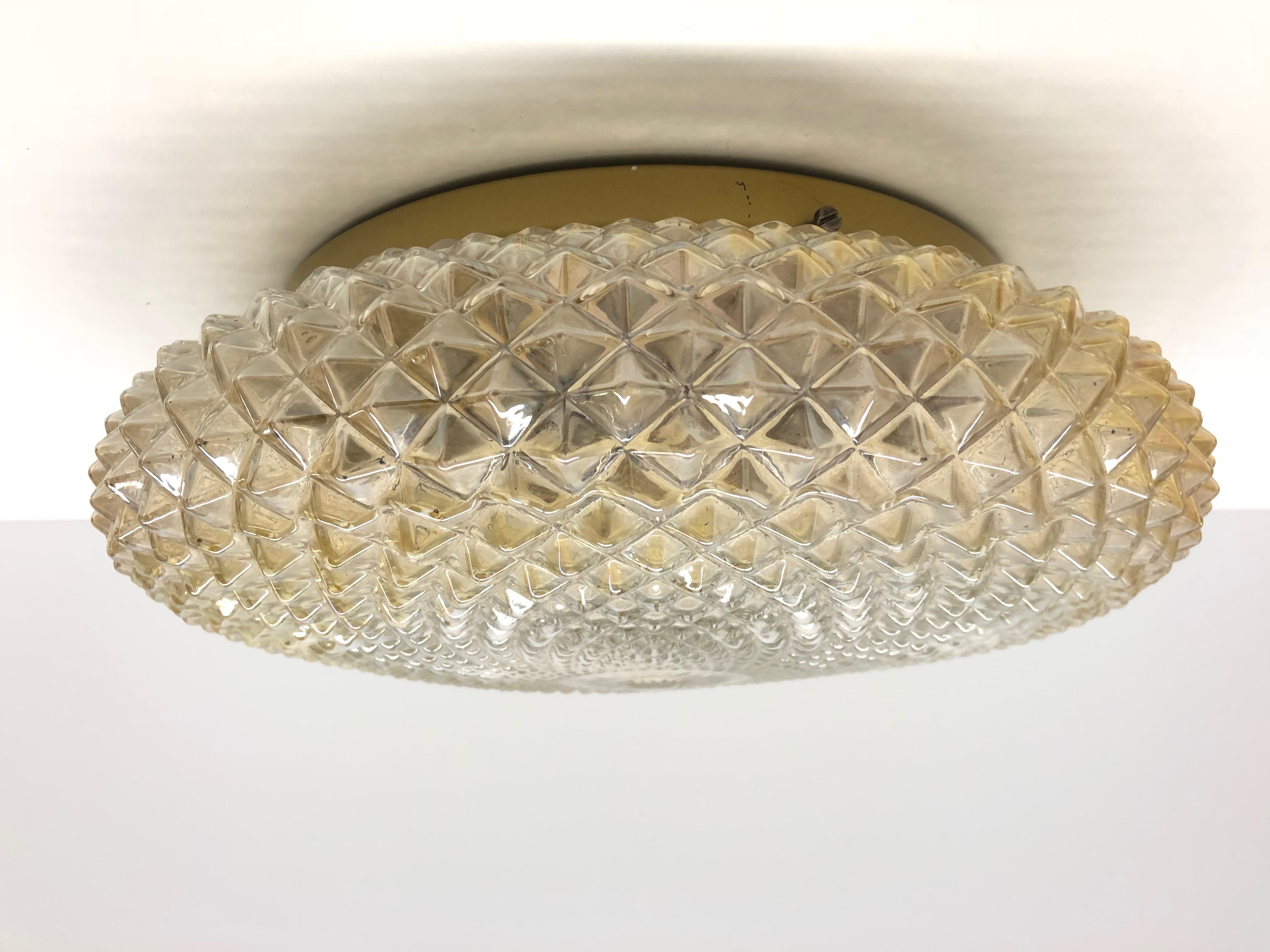 Stunning large Crystal pattern amber glass flush mount. Made in Germany by Glashütte Limburg. Gorgeous textured glass flush mount with metal fixture. The fixture requires two European E27 Edison or Medium bulb up to 60 watts.