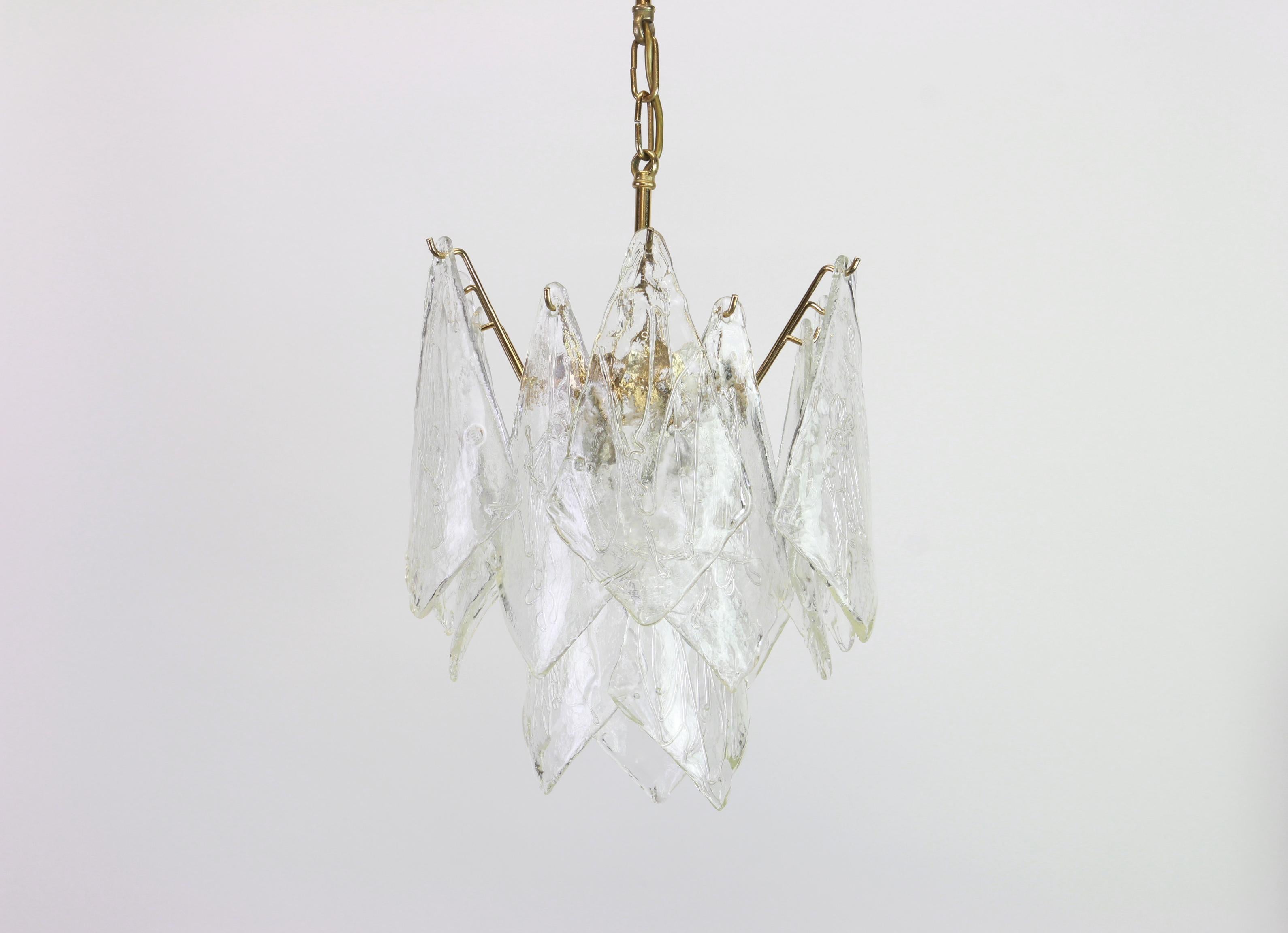 A stunning Murano glass Chandelier designed by Carlo Nason for Mazzega, Italy, manufactured in the 1970s. 
The chandelier is composed of 15 thick textured glass elements attached to a brass metal frame.

High quality - very good condition.