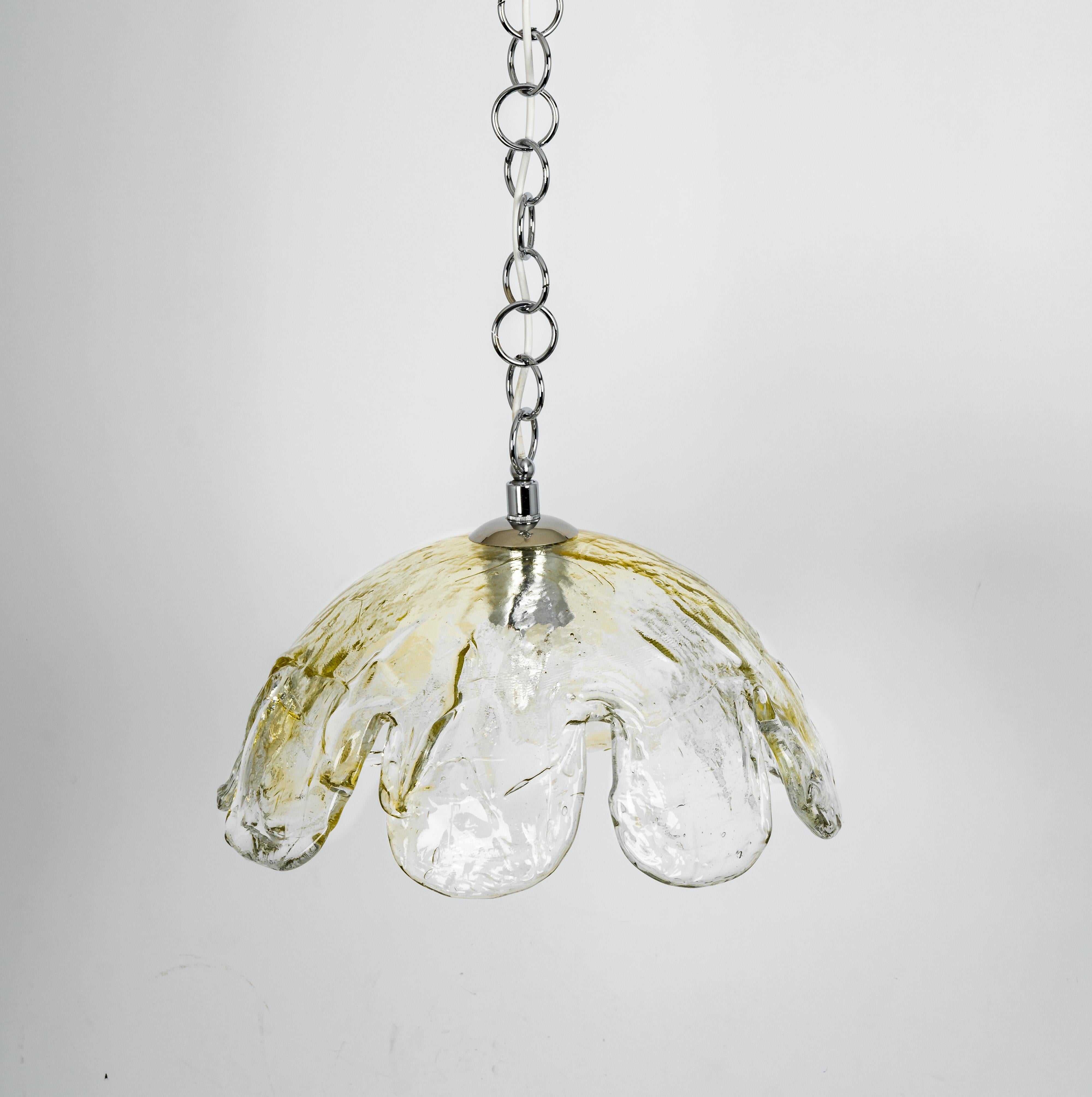 A stunning large Murano Glass pendant light designed by Kaiser, Germany manufactured in the 1960s.
The chandelier is composed of a thick Murano glass element attached to a metal frame.

High quality and in very good condition. Cleaned, well-wired
