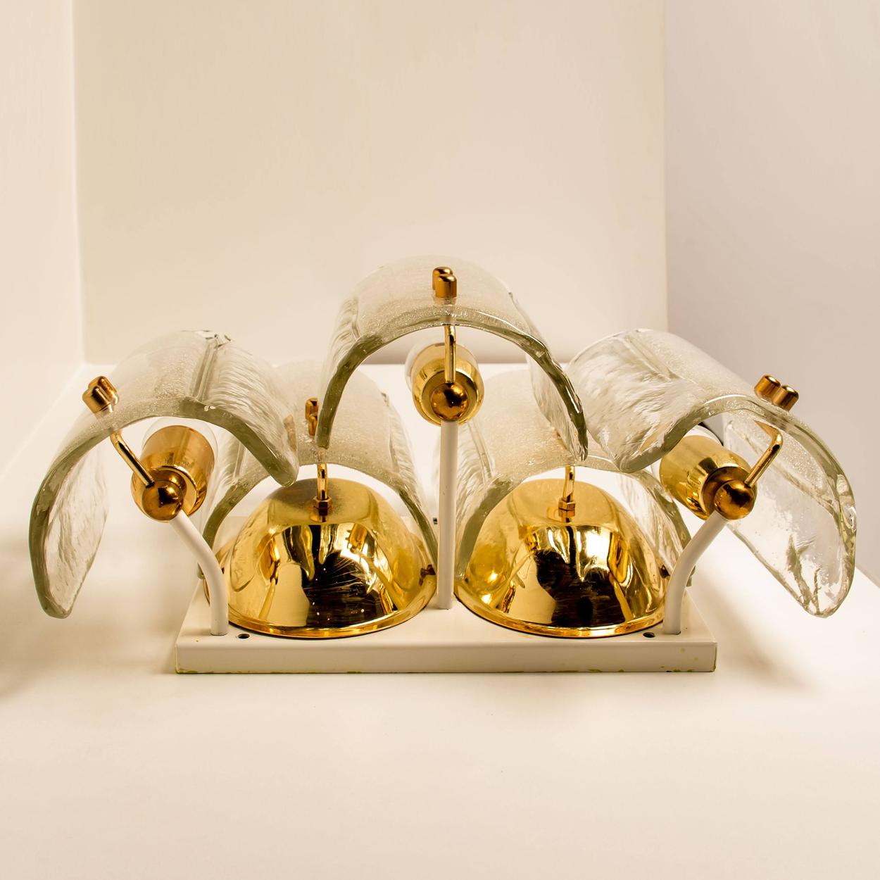 Pair of unique large and elegant glass wall sconces in the style of J.T. Kalmar, manufactured in the 20th century, circa 1970 (late 1960s or early 1970s). A pair of wonderful high-end wall light fixtures with brass detail and 5 thick textured blown