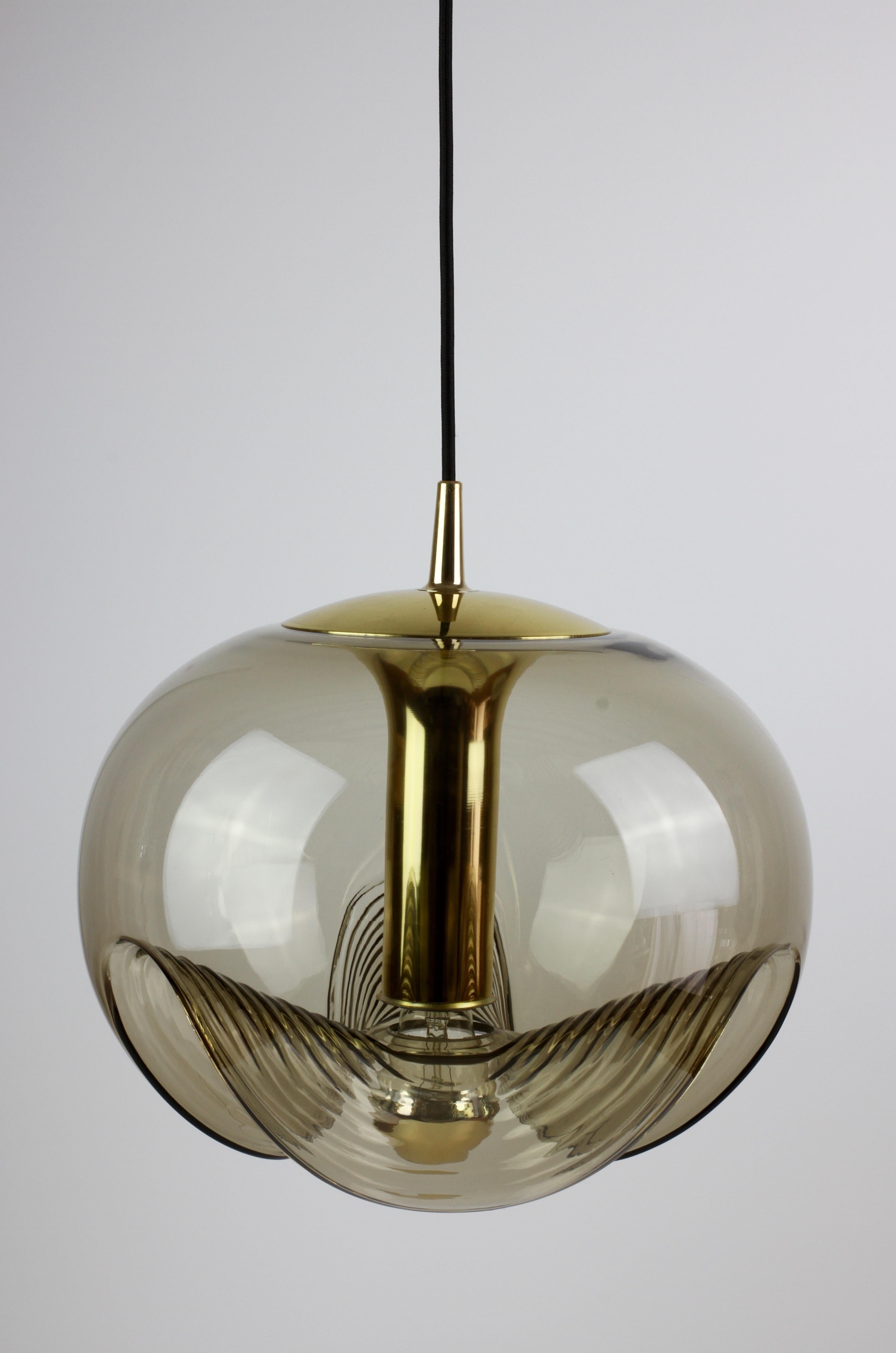 One of a beautiful pair mid-century design by Koch & Lowy for Peill & Putzler in the 1970s. This is an absolutely classic piece of design, featuring a smoked colored (colored) glass globe shade with a waved / ribbed moulded bubble form, casting a