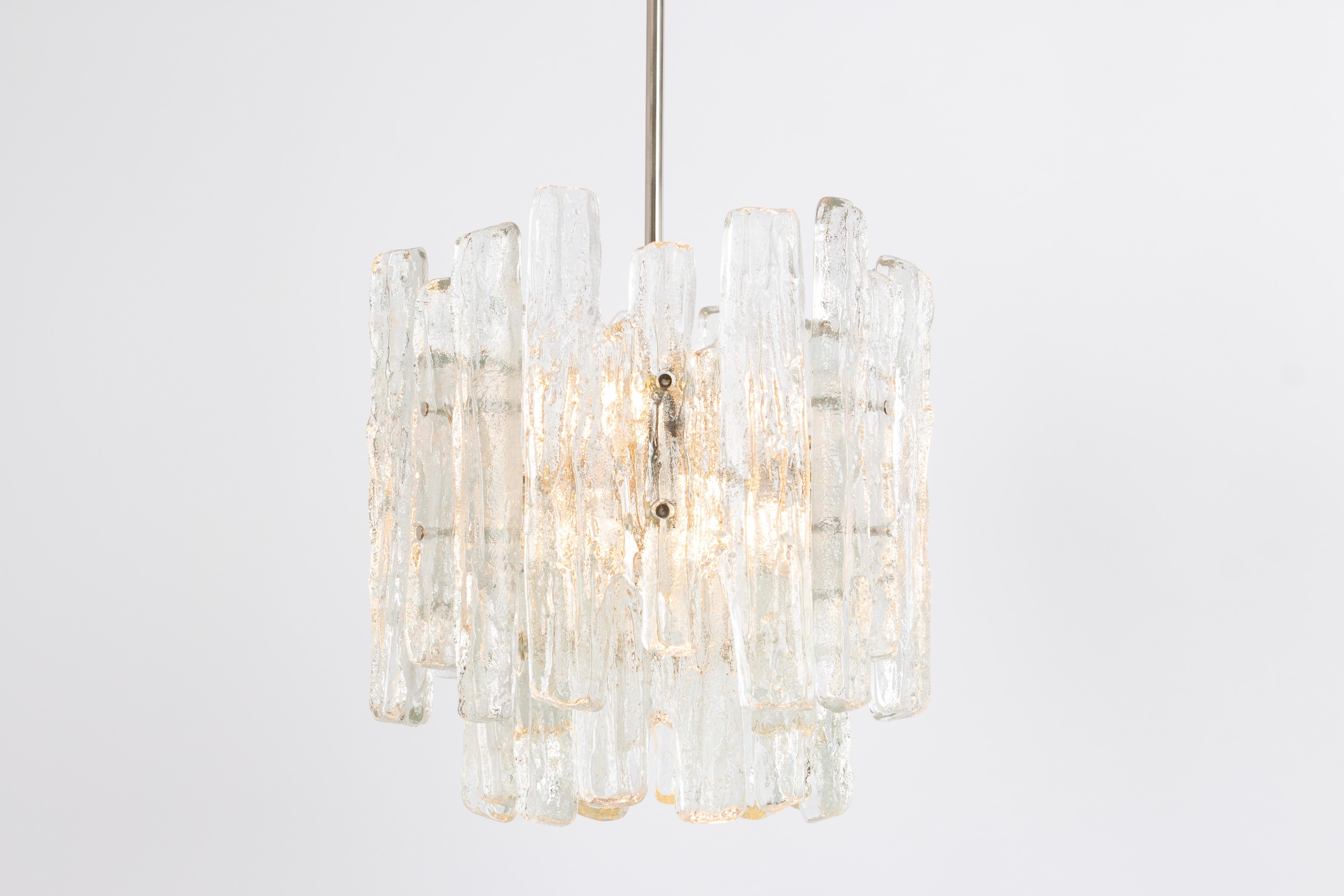 1 of 2 Stunning Murano glass chandelier by Kalmar, 1960s
Two tiers gather structured glasses, beautifully refracting the light, very heavy quality.

High quality and in very good condition. Cleaned, well-wired, and ready to use. 

The fixture