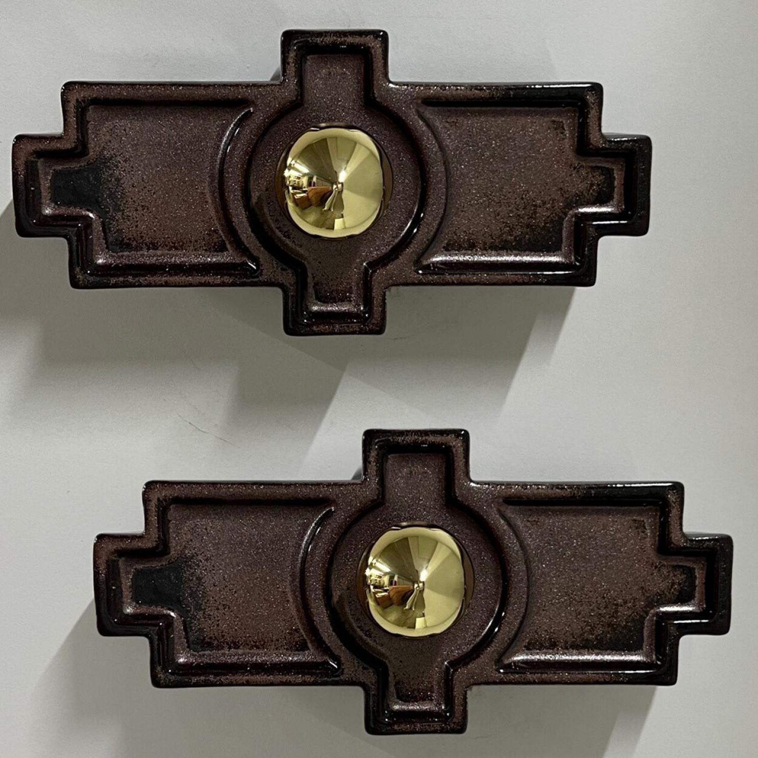 Rectangular brown ceramic wall lights in Fat Lava style. Manufactured in Germany in the 1970s.

The glaze has a brown color gradient. They can be placed horizontally or vertically.

We used gold light bulbs (see images), but silver amber or clear