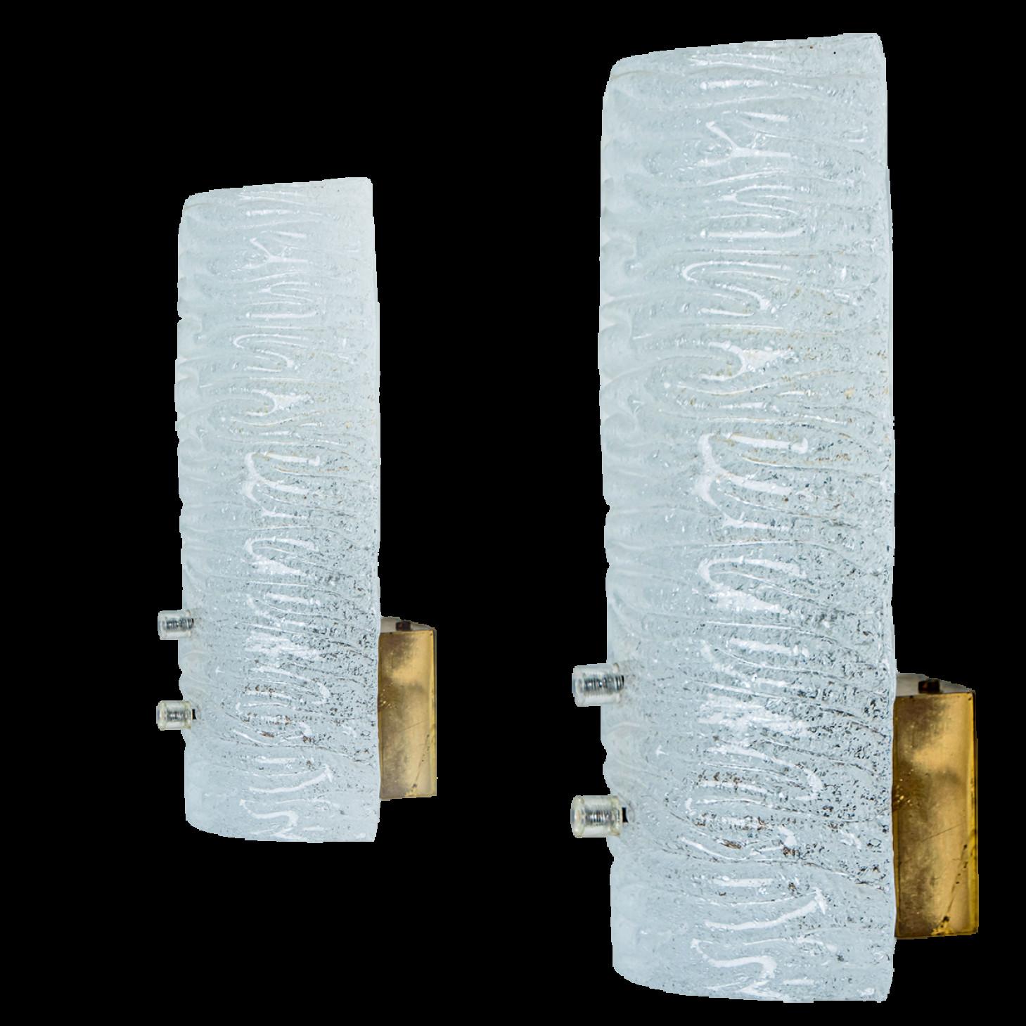 Beautiful and elegant modern brass wall lights or sconces, manufactured by J.T. Kalmar Austria in the 1960s. Lovely design, executed to a very high standard.

Each light has one ribble textured glass column on it. Clean lines to complement all