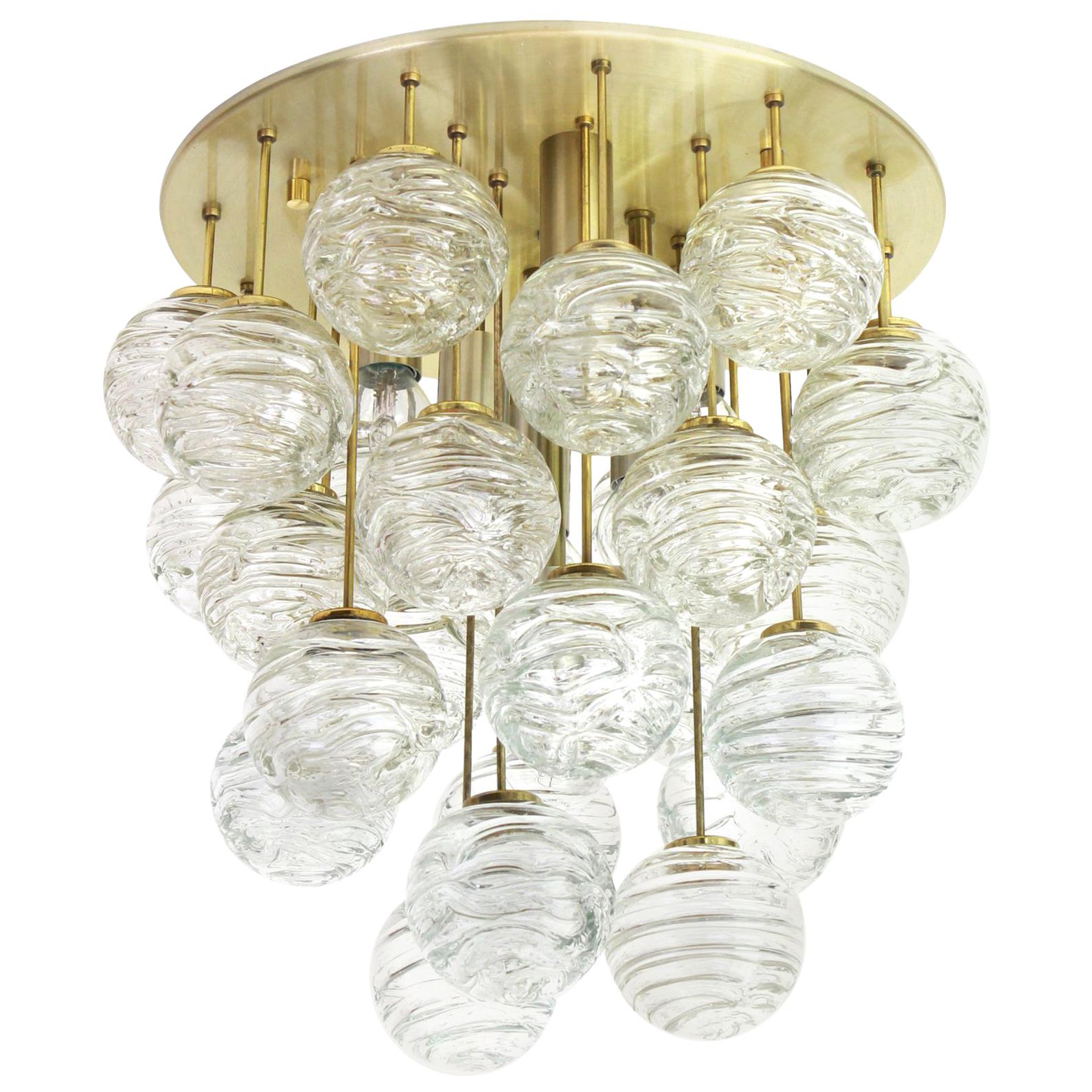 A Petite midcentury flushmount made by Doria Leuchtern, manufactured in Germany, circa 1970-1979.

The flushmount is composed of many Glass swirl textured ice glass elements (snowballs) attached to a brass frame.
Made by Doria in Germany,