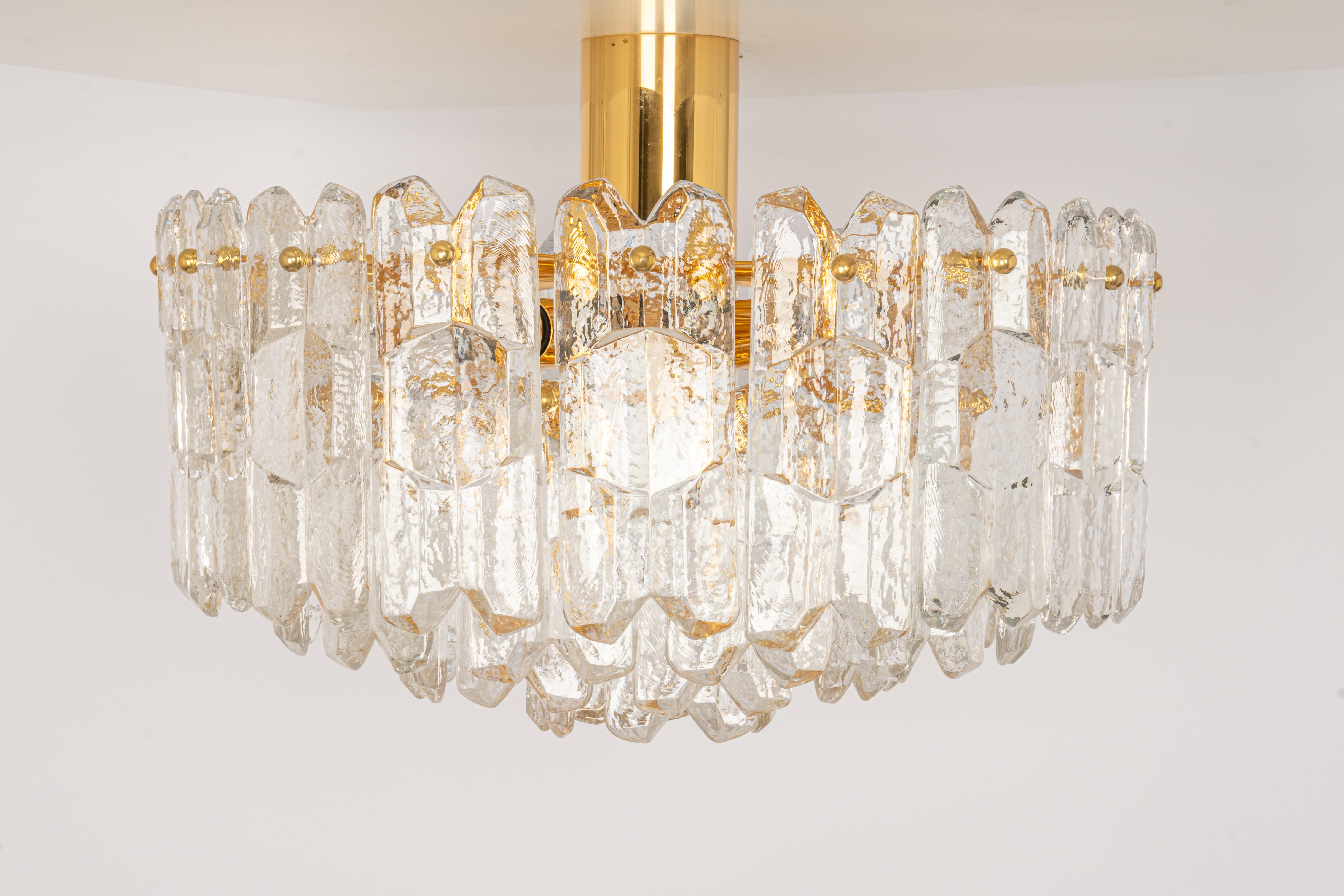 A wonderful gilt brass light fixture comprises crystal Murano glass pieces on a gilded brass frame. Its made by Kalmar (Serie: Palazzo), Austria, manufactured, circa 1970-1979.

It needs 12 small bulbs (E-14 , 40 W for each bulb)
Light bulbs are not