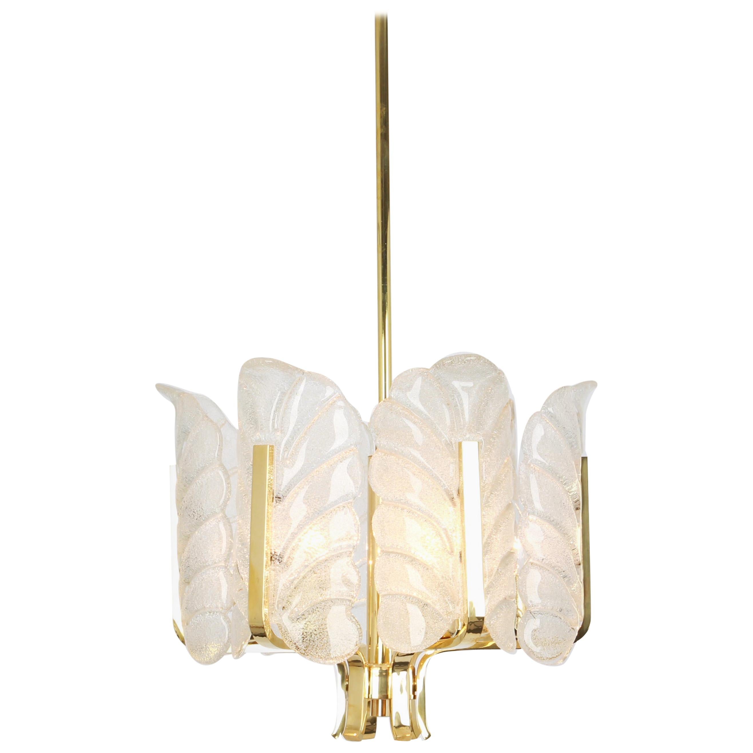 Very glamorous chandelier designed by Carl Fagerlund for Orrefors glass, Sweden, manufactured in midcentury, circa 1960-1969. The light features a polished brass frame with six stunning Murano glass leaves which have a matte frosted relief on the