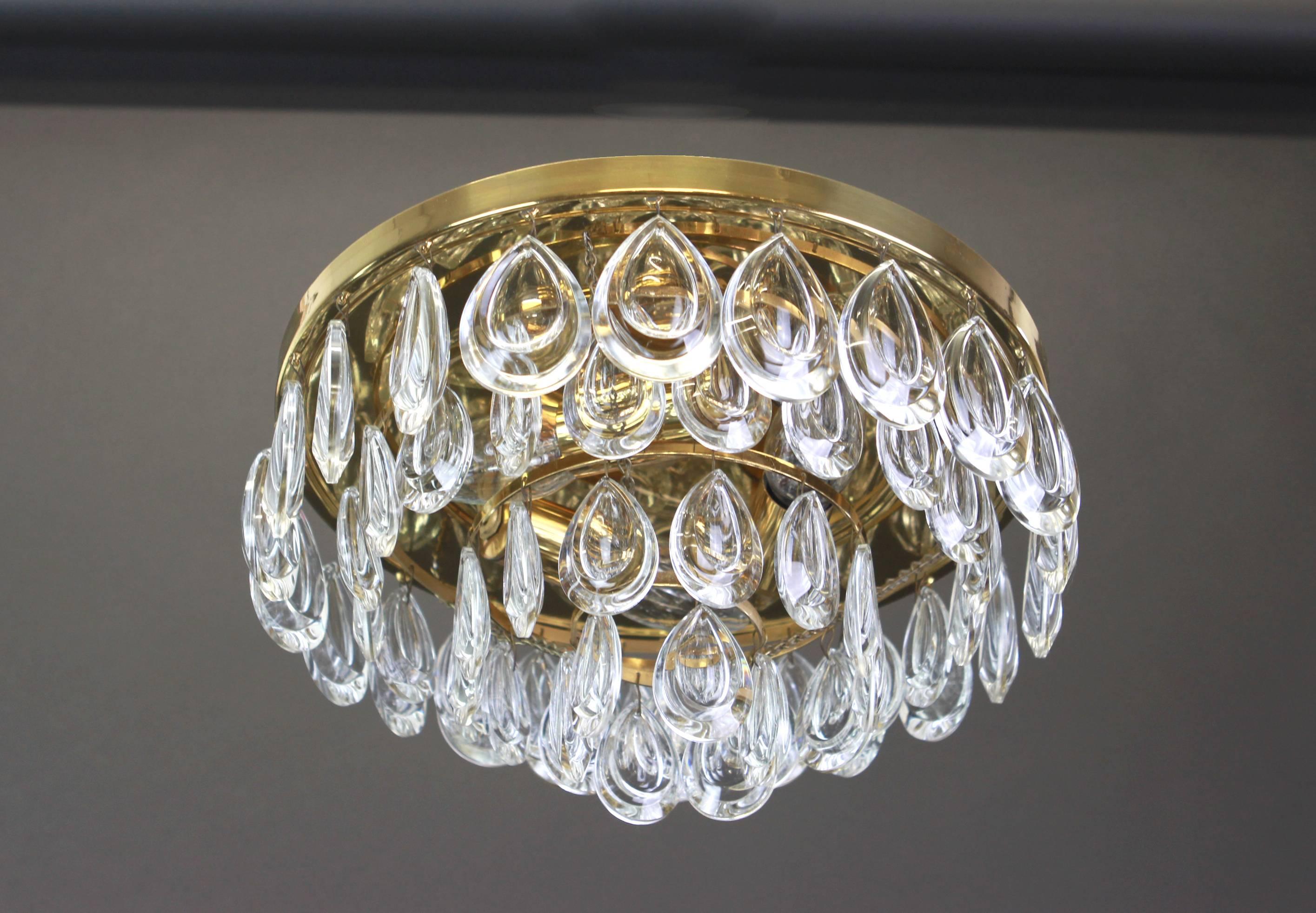 A stunning small four-tier flushmount by Palwa, Germany, manufactured in circa 1970-1979. A handmade and high-quality piece. The ceiling fixture and the frame are made of brass and have four rings with lots of faceted crystal glass elements.

High