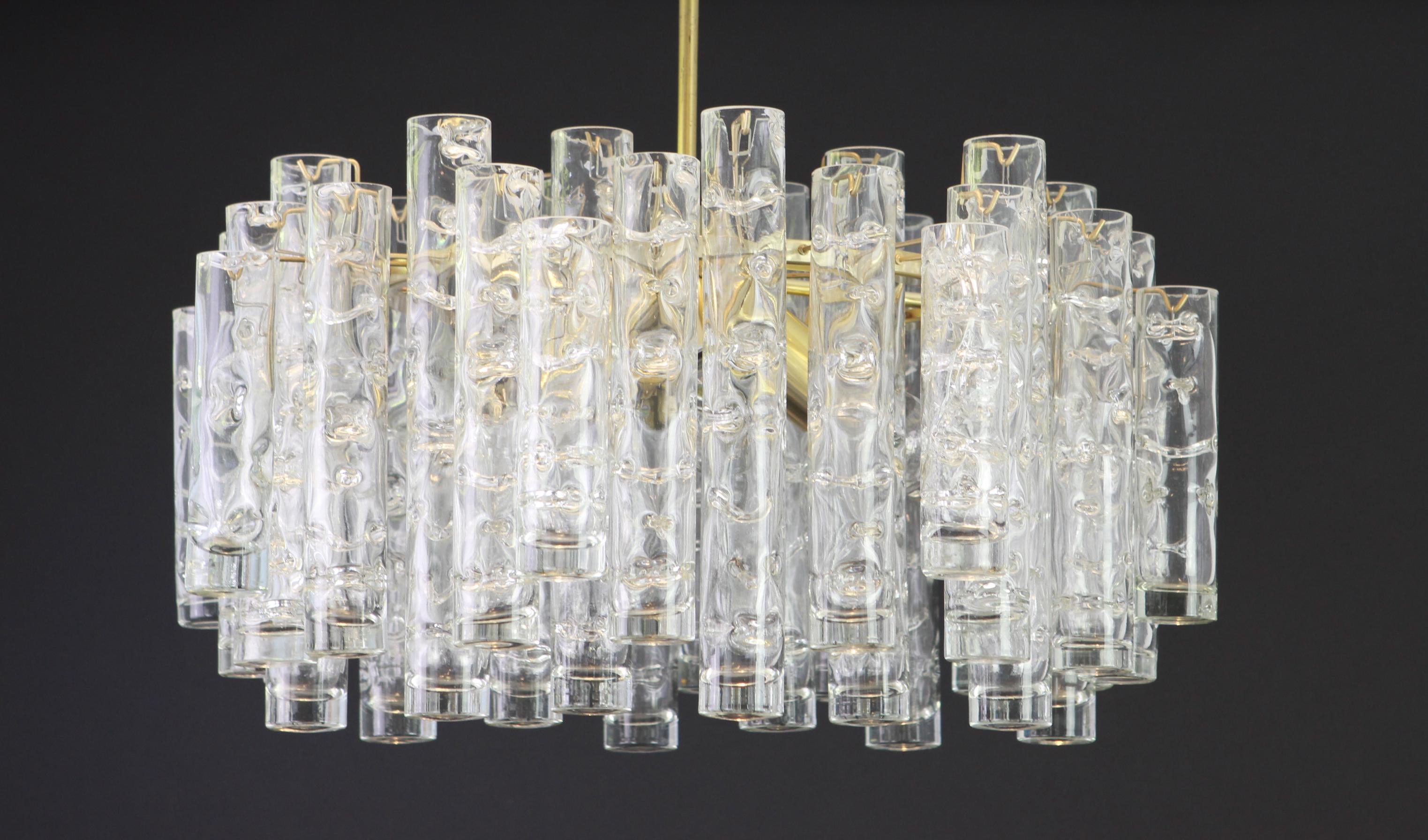 Fantastic midcentury chandelier by Doria, Germany, manufactured circa 1960-1969. A lot Murano glass cylinders suspended from the fixture.

Heavy quality and in very good condition. Cleaned, well-wired and ready to use.

The fixture requires 4 x