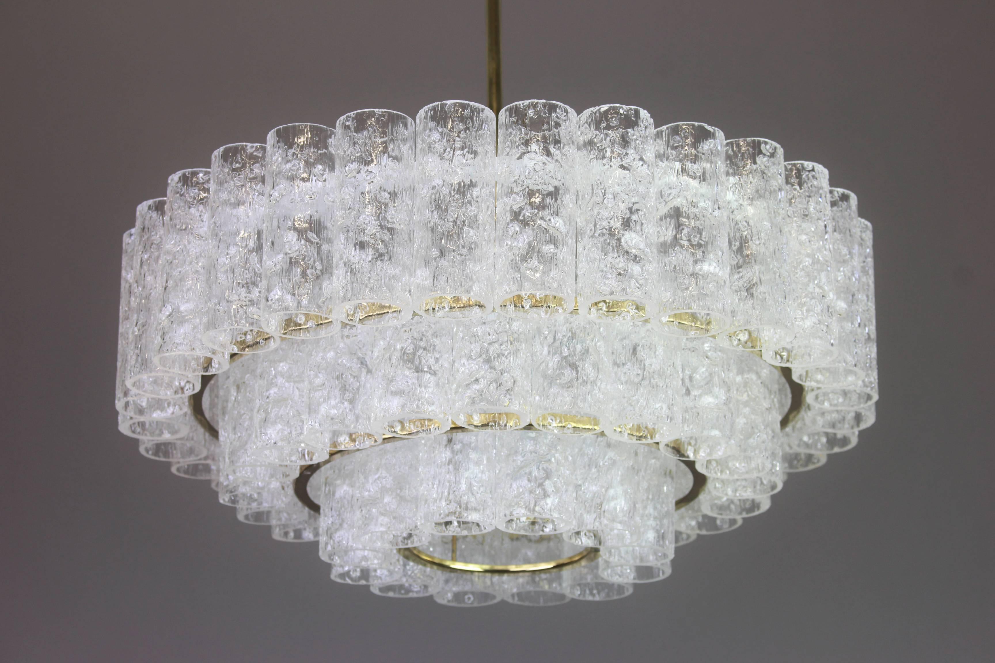 Fantastic three-tier midcentury chandelier by Doria, Germany, manufactured, circa 1960-1969. Three rings of Murano glass cylinders suspended from a fixture.
Heavy quality and in very good condition. Cleaned, well-wired and ready to use.
The