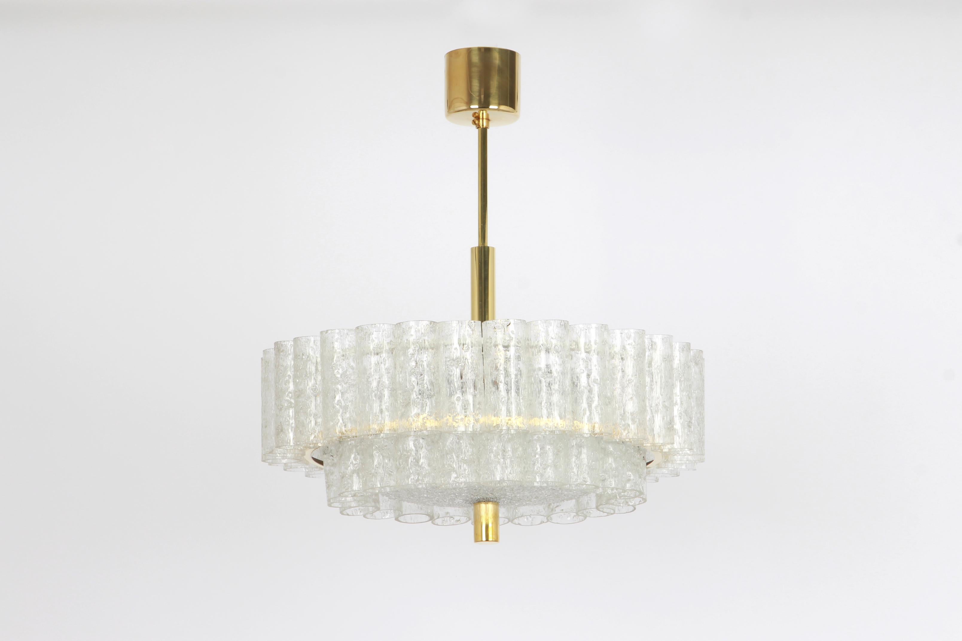 1 of 2 Fantastic two-tier midcentury chandeliers by Doria, Germany, manufactured circa 1960-1969. Two rings of Murano glass cylinders suspended from a fixture.

Heavy quality and in very good condition. Cleaned, well-wired and ready to use. 

The