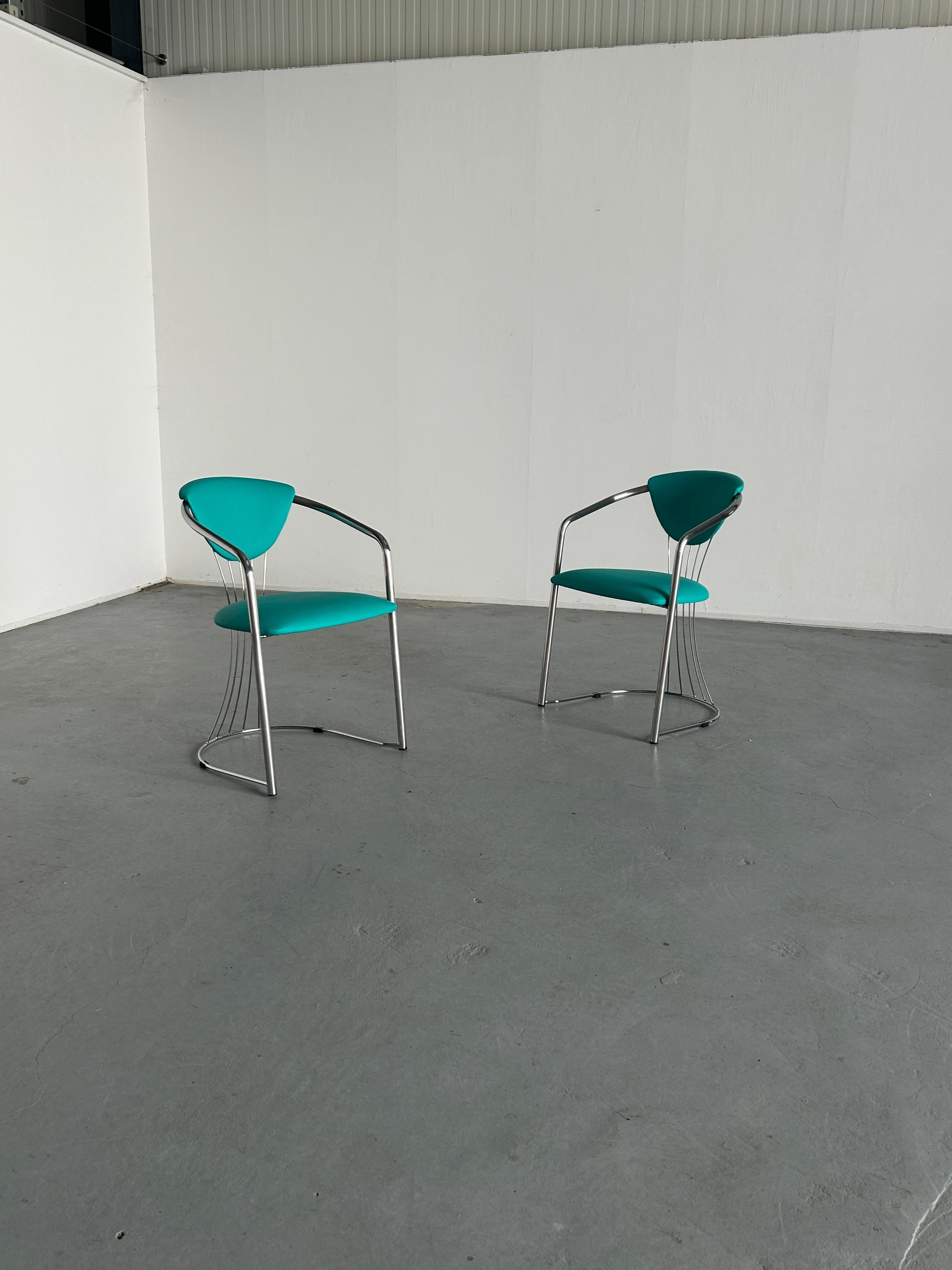 Two vintage Italian chrome and mint/teal green faux leather dining chairs, produced by Effezeta, 1990s Italy.

Quality made and in good vintage condition with expected signs of age, as can be seen from the photos.
Reupholstered. Smaller damages on