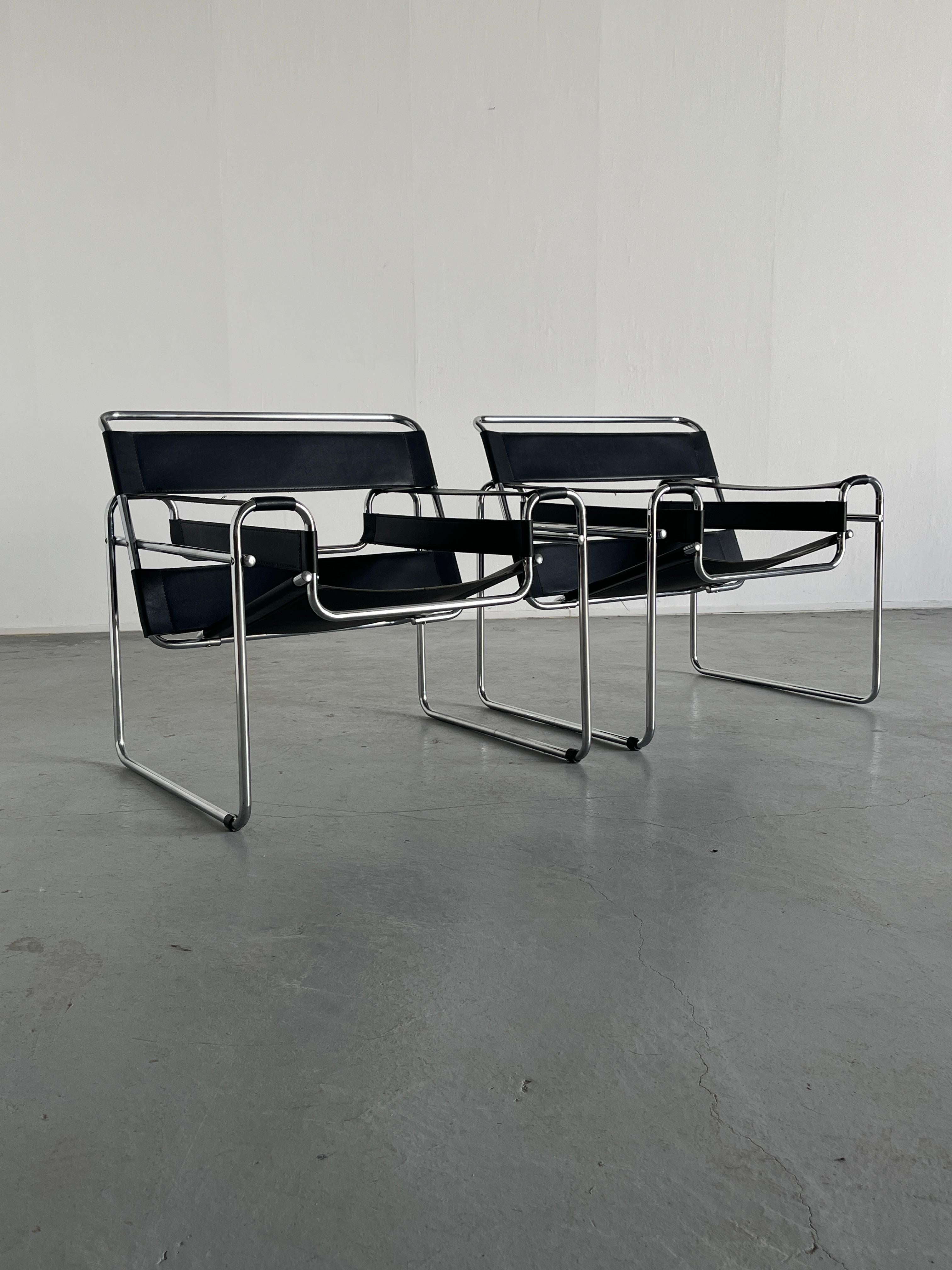 Two iconic Wassily armchairs designed by Marcel Breuer in 1925/26, also known as the 'B3' chair.
Unknown but quality vintage Italian production, circa 1970s.

Made from thick faux leather and chrome.

Overall in good vintage condition with some