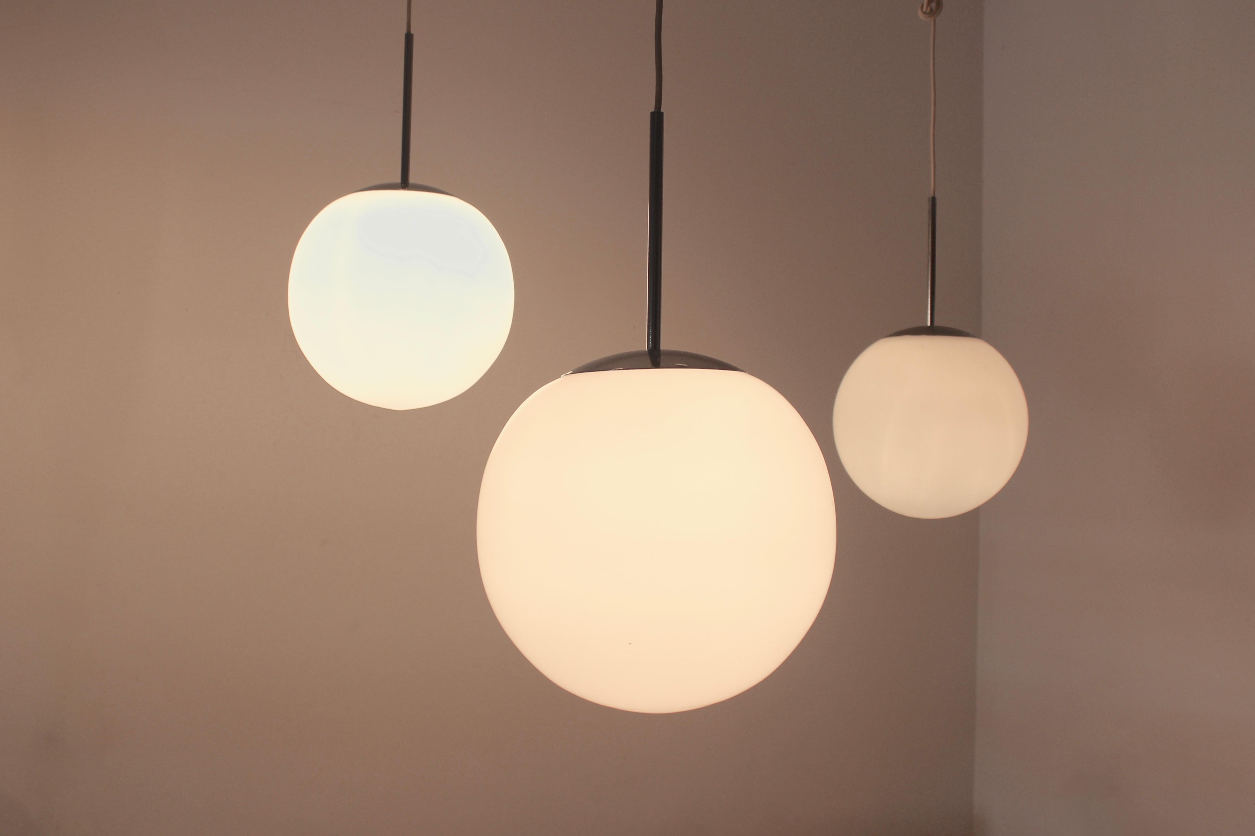Iconic bubble pendant lamp manufactured by Peill & Putzler and the design is attributed to Wilhelm Wagenfeld in Germany in the 1960s. Comes in beautiful white frosted opal glass with chrome suspension. Made in Germany, lamp is labelled. The fixture