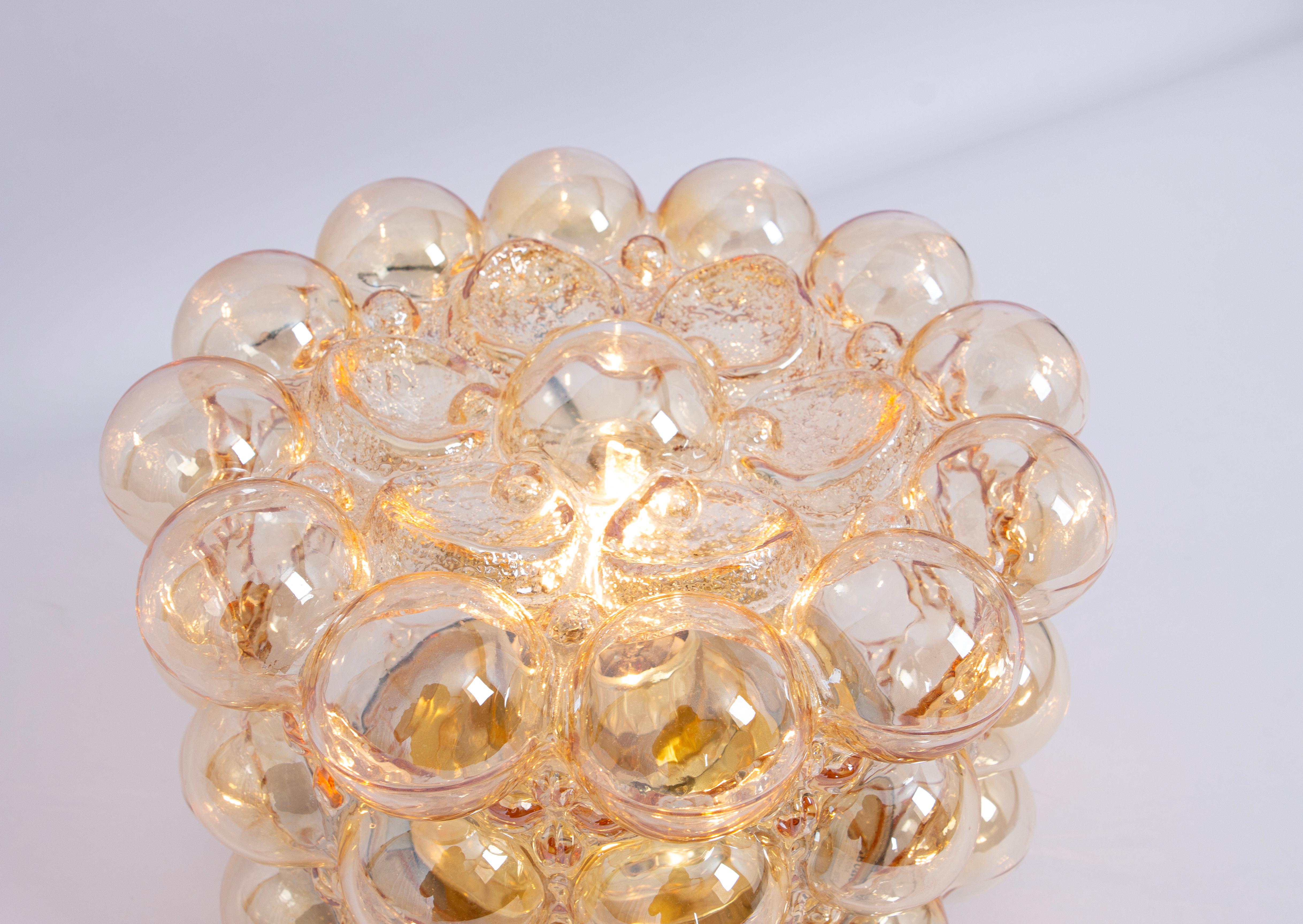 1 of 3 Amber bubble glass Flushmount light by Helena Tynell, Limburg, Germany.
High quality and in very good condition. Cleaned, well-wired, and ready to use. 

The Limburg Bubble Glass Flush Mount provides a warm and inviting illumination that