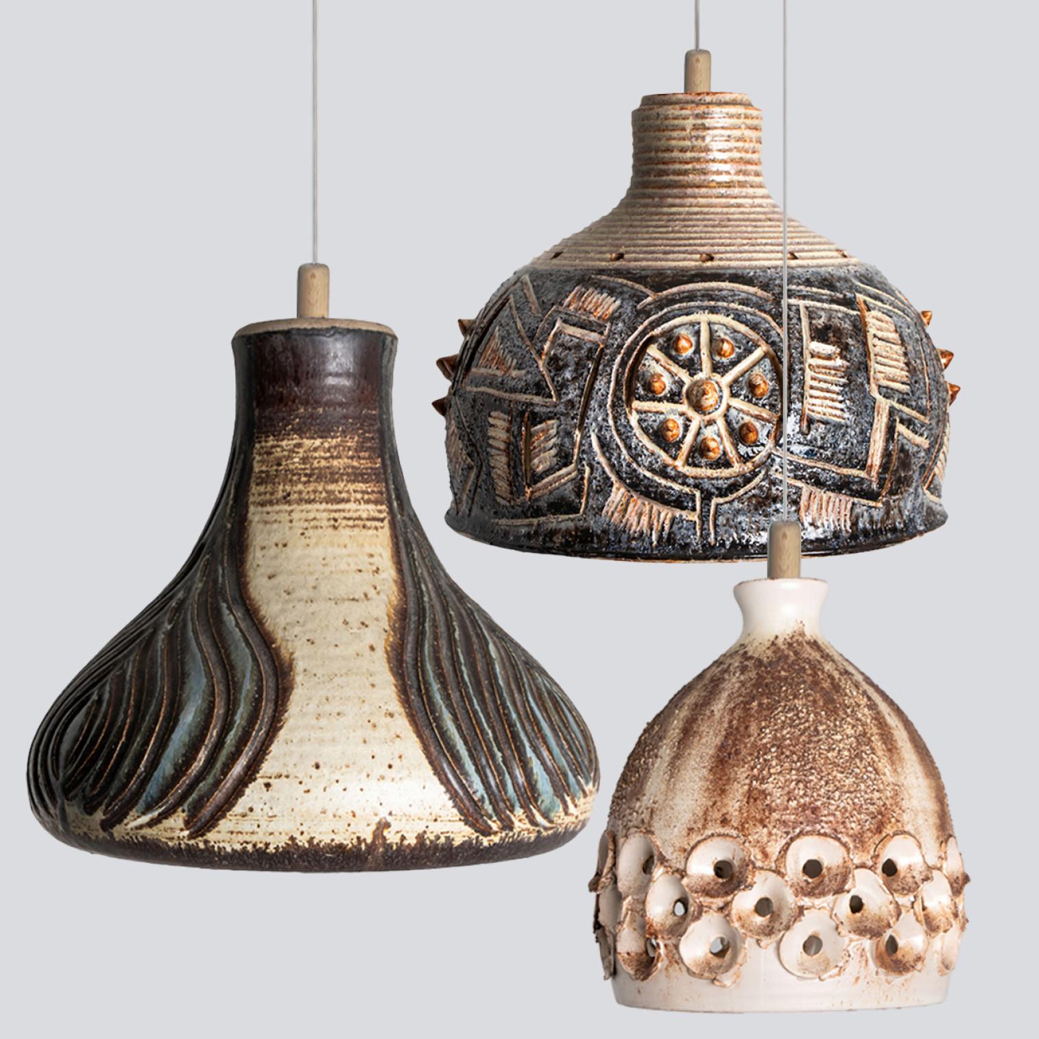 Playful arrangement of stunning round hanging lamps with an unusual shape, made with beautifully colored anthracite, Ivory and light blue and brown ceramics, manufactured in the 1970s in Denmark. We have a multitude of unique colored ceramic light
