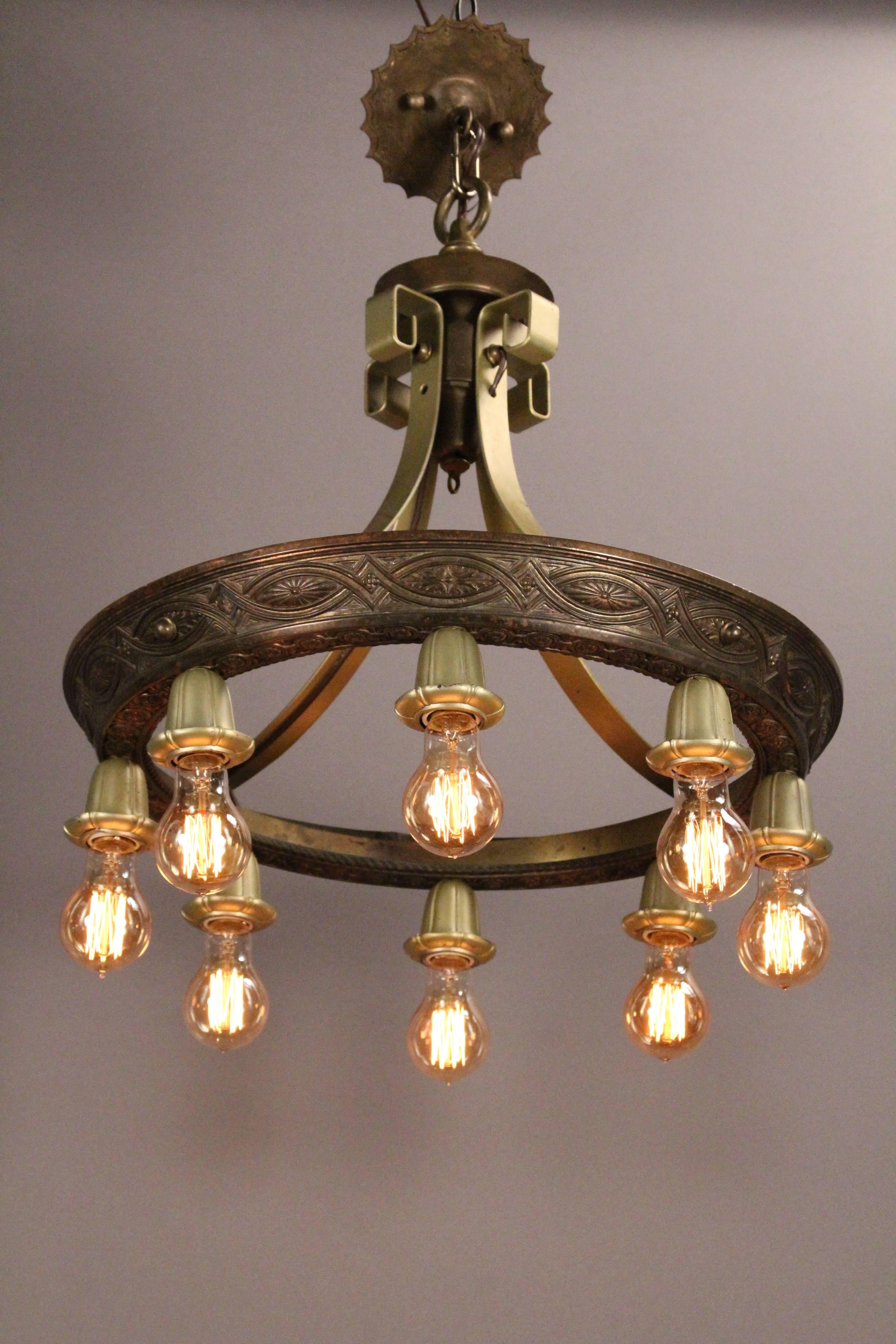 Sold and priced individually, circa 1920s chandelier with eight light would fit nicely in Spanish Revival or English Tudor. Measures: 22.5
