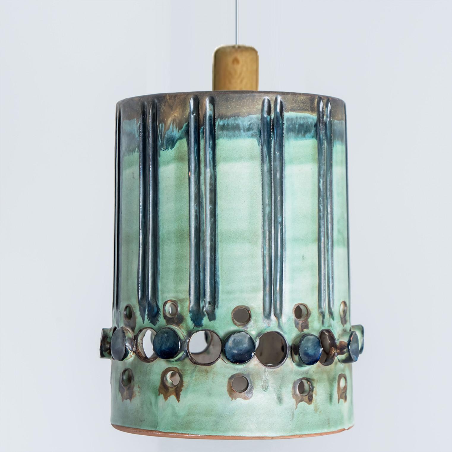 Playful arrangement of stunning round hanging lamps with an unusual shape, made with rich colored blue ceramics, manufactured in the 1970s in Denmark. We have a multitude of unique colored ceramic light sets and arrangements, all available in our
