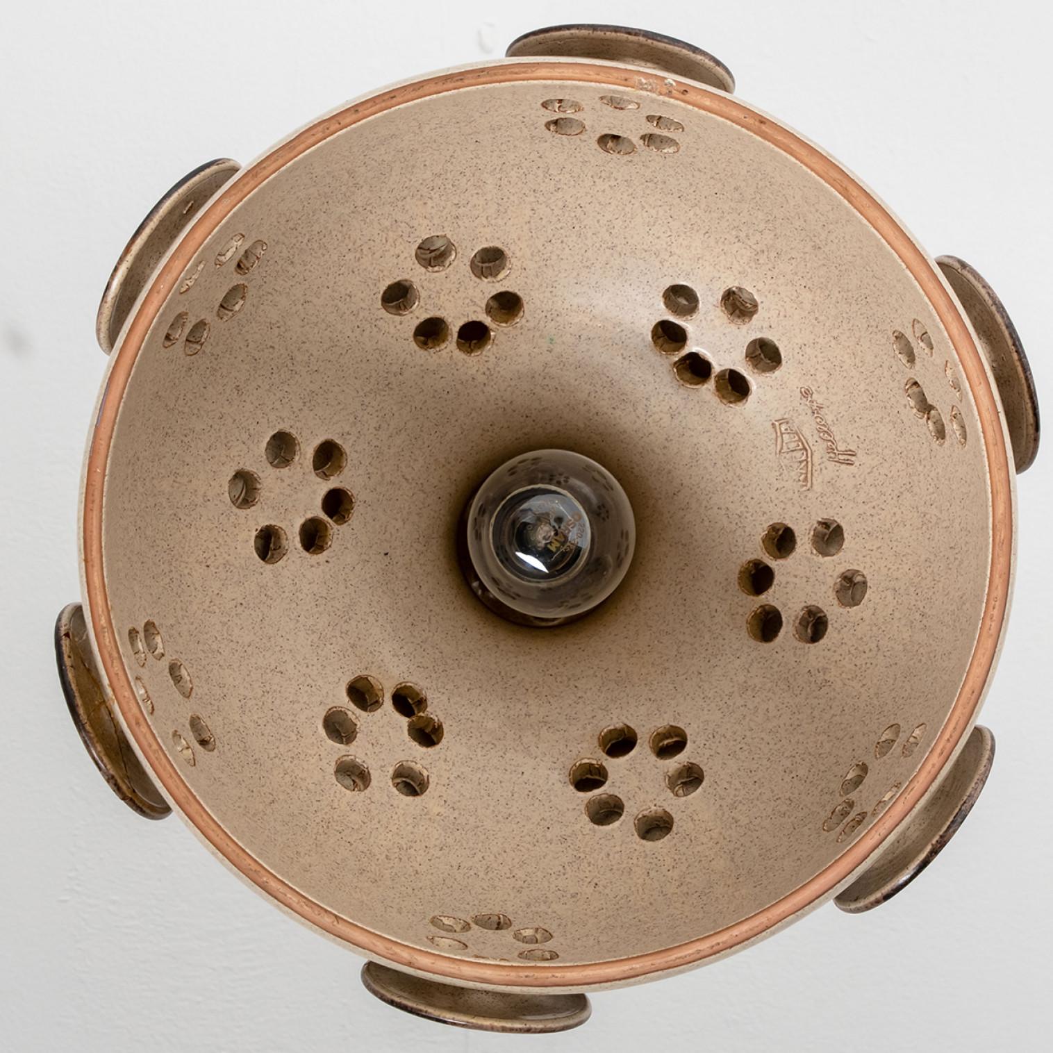 Playful arrangement of stunning round hanging lamps with an unusual shape, made with rich terra colored brown ceramics, manufactured in the 1970s in Denmark. We have a multitude of unique colored ceramic light sets and arrangements, all available in