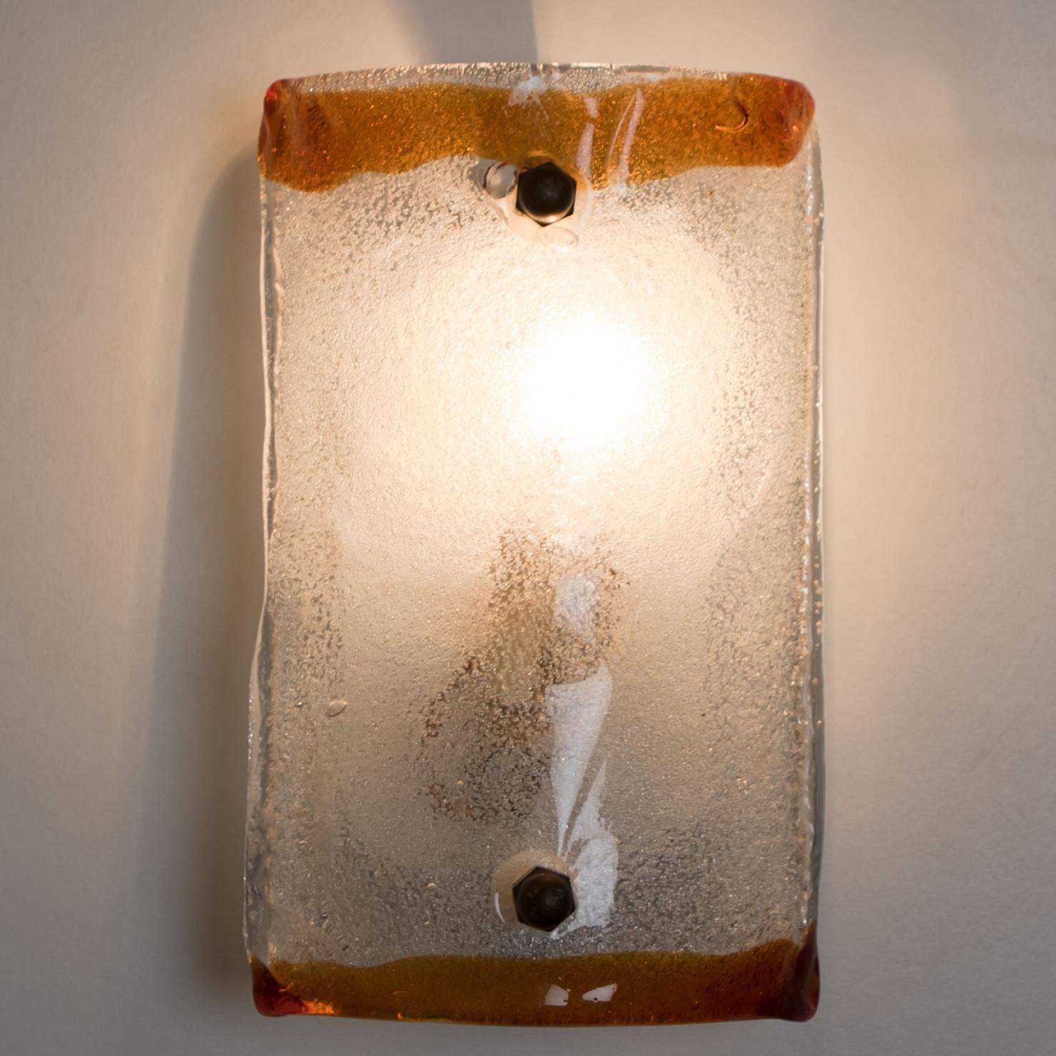 Beautiful rectangle wall light made by Carlo Nason. With a crystal clear glass plate, and brown edges, this beautiful piece made in thick handmade Murano glass creates a warm aesthetic.

Dimensions:
Height: 9.05
