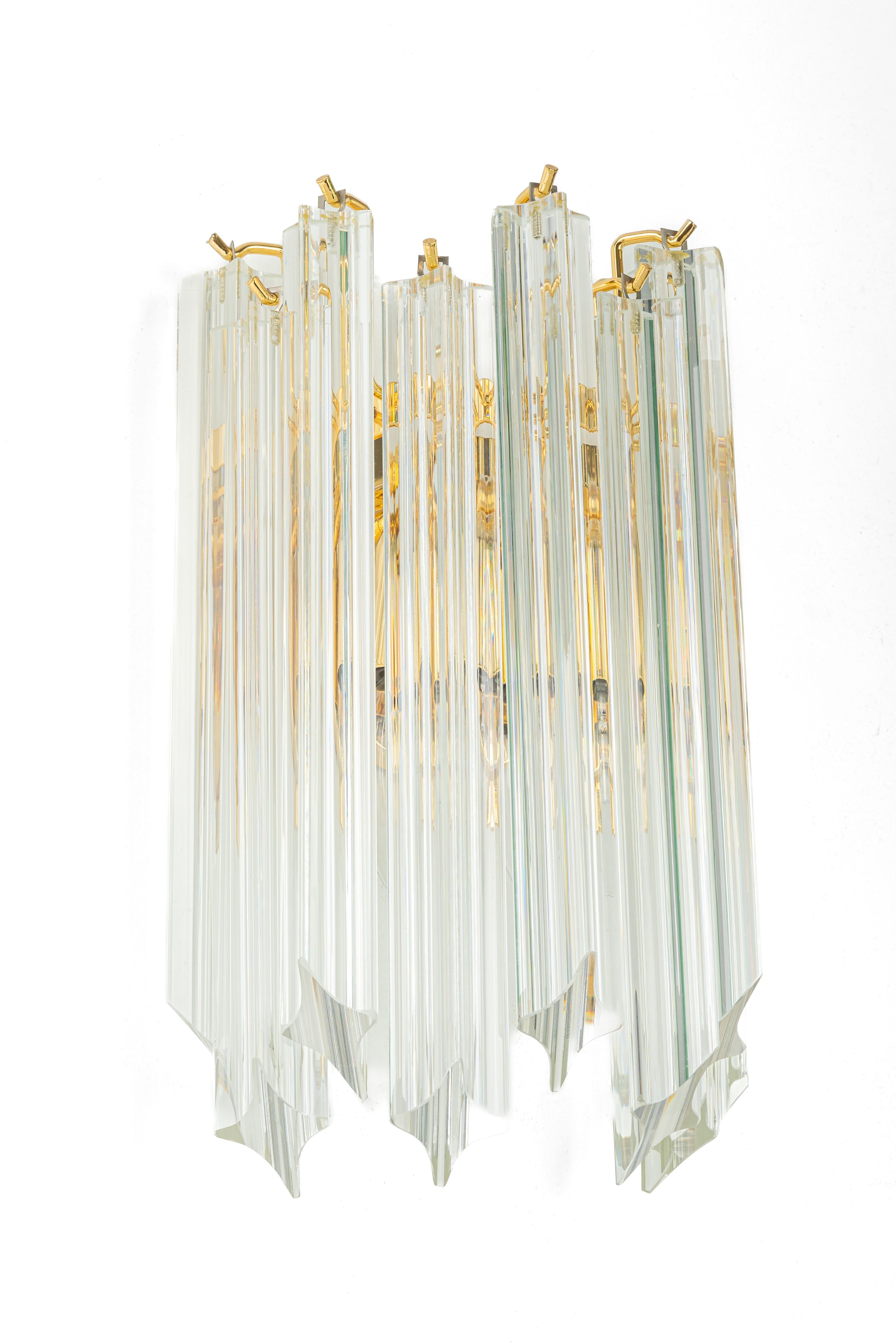 Each wall light is composed of 9 crystal glasses and a gilt brass frame design in Venini style, Italy. Manufactured circa 1980s.
High quality and in very good condition. Cleaned, well-wired, and ready to use. 

Each fixture requires two small