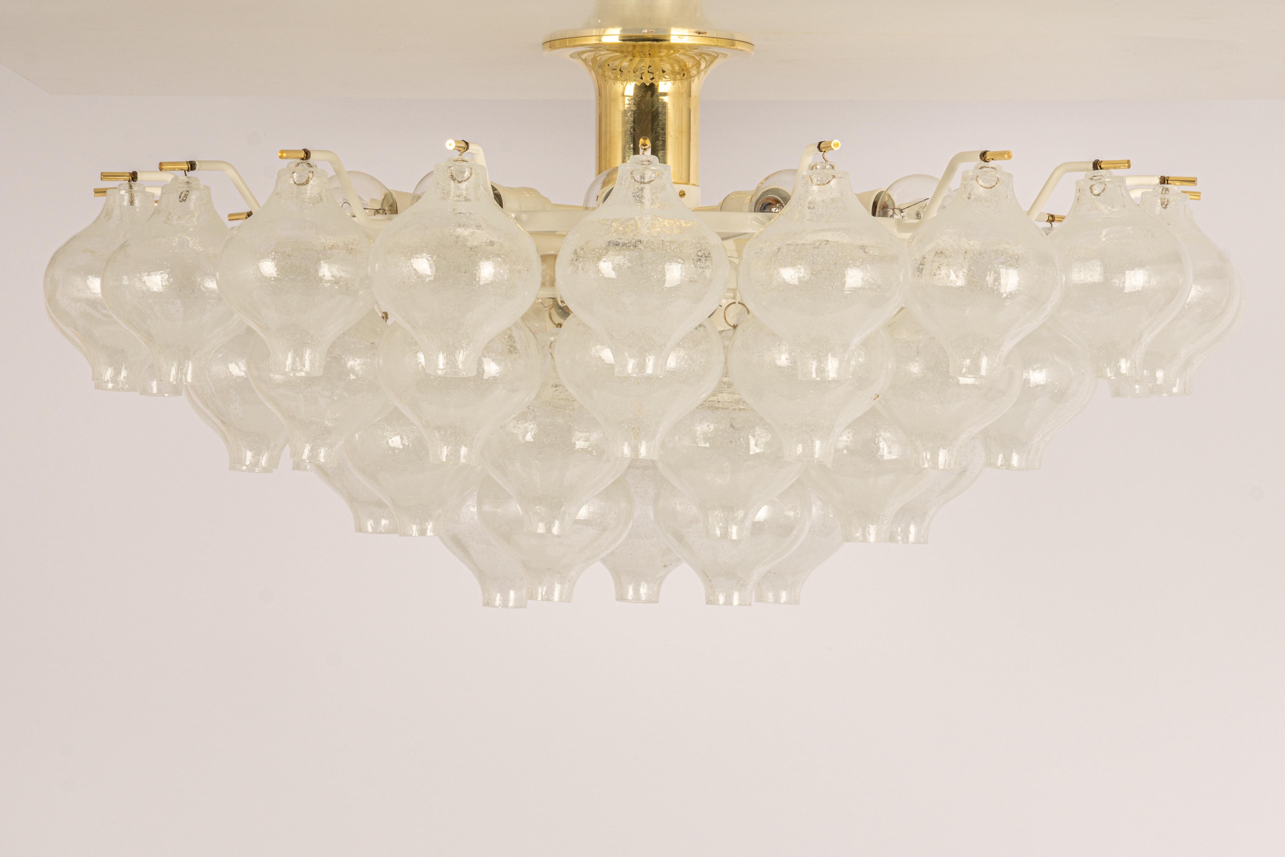 Wonderful onion-shaped -Tulipan glass chandelier. Forty-nine hand-blown glasses suspended on a white-colored metal frame.

The Kalmar Tulipan Chandelier is a stunning and timeless lighting fixture that combines elegance, craftsmanship, and a touch