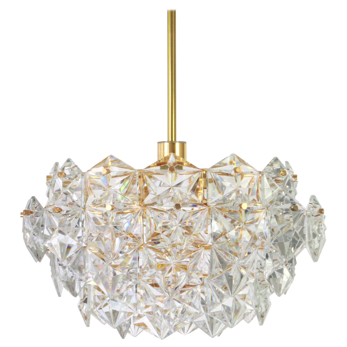 A stunning five-tier chandelier by Kinkeldey, Germany, manufactured in circa 1970-1979. A handmade and high quality piece. The chandelier features a 24-karat gold-plated four-tier structure with lots of facetted crystal glass elements.

High