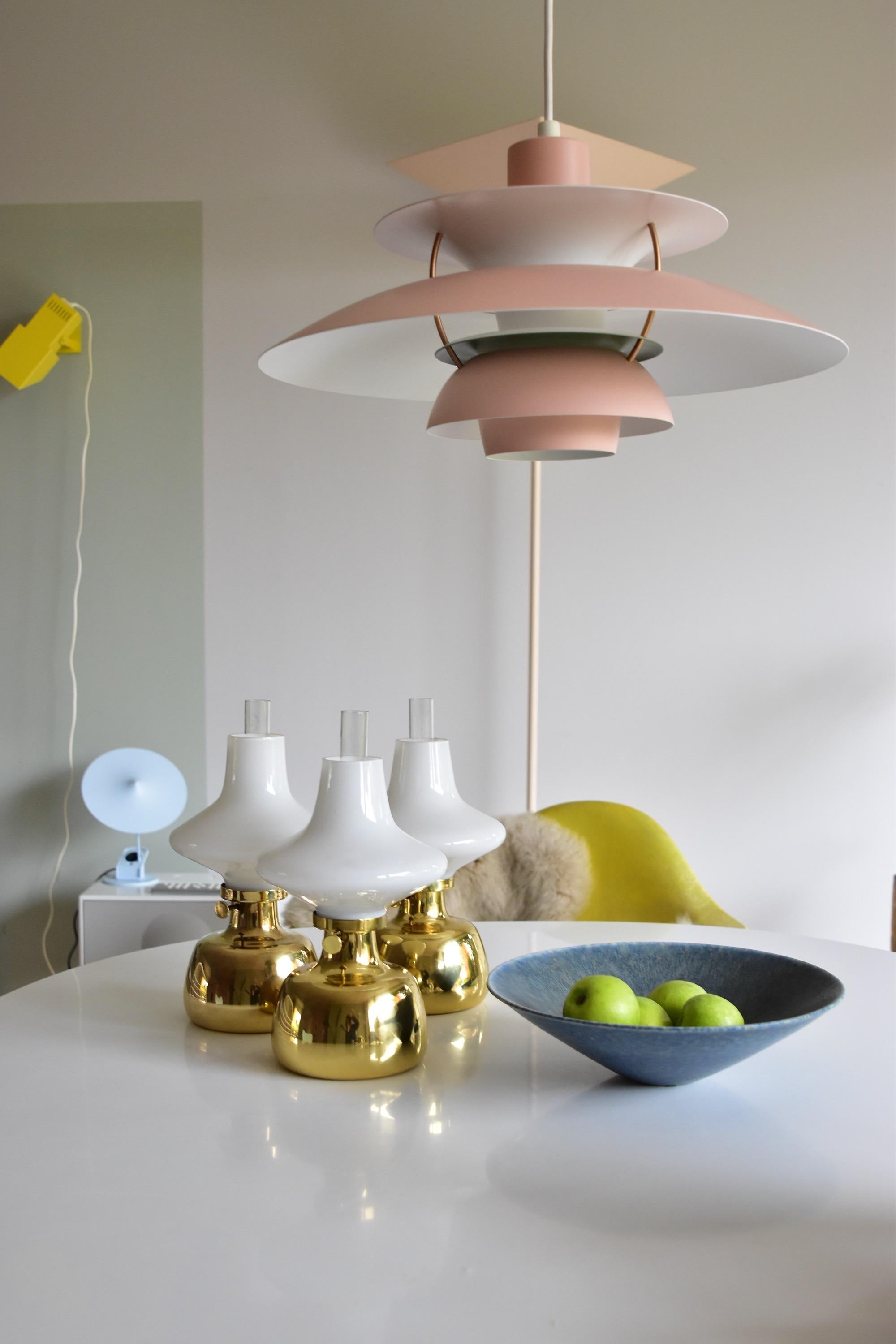 This design dates back to 1962 when Henning Koppel designed this light for his holiday home. It was taken into production by Louis Poulsen in 1965 and has been in production by them until 2006.
The Petronella oil table lamp is made from solid brass